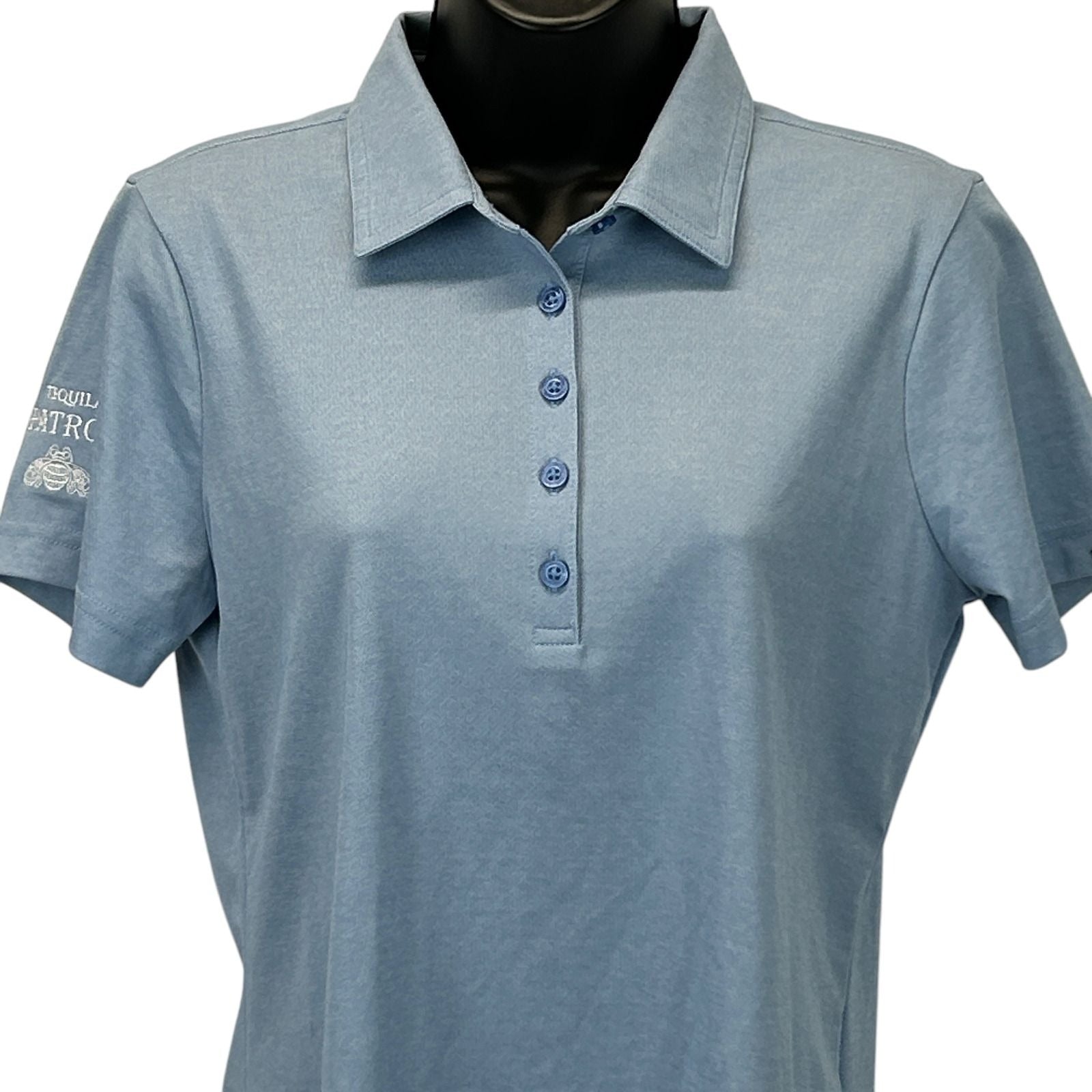 Travis Mathew Patron Tequila Polo Shirt in Light Blue, Front View with logo on left chest