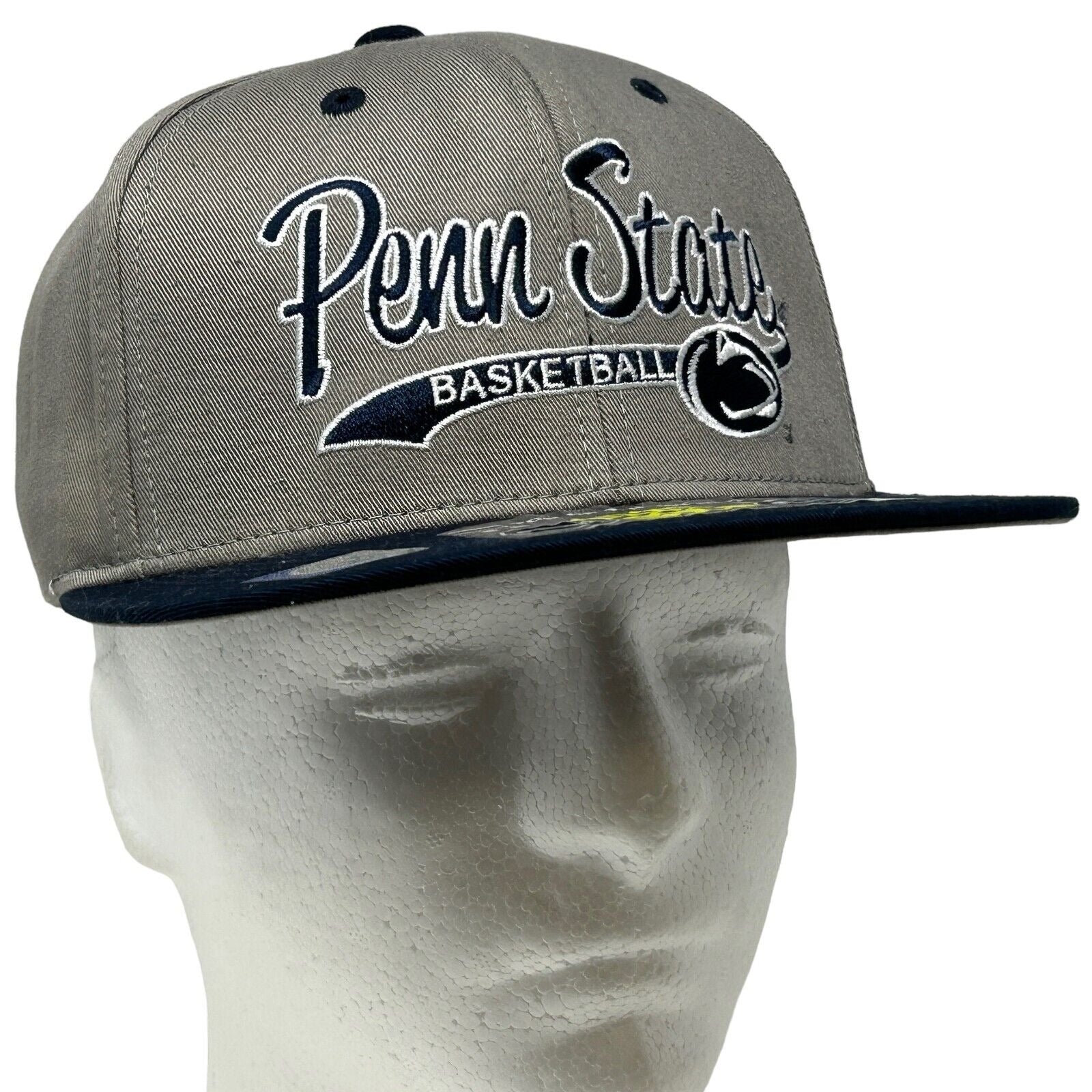 Gray Penn State Nittany Lions basketball hat with logo and flat brim view from the side