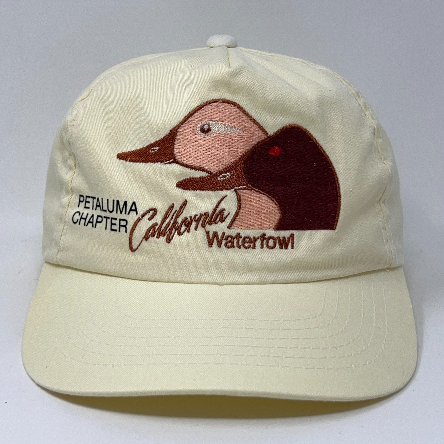 Tan baseball cap featuring embroidered ducks and Petaluma Chapter California Waterfowl logo on the front