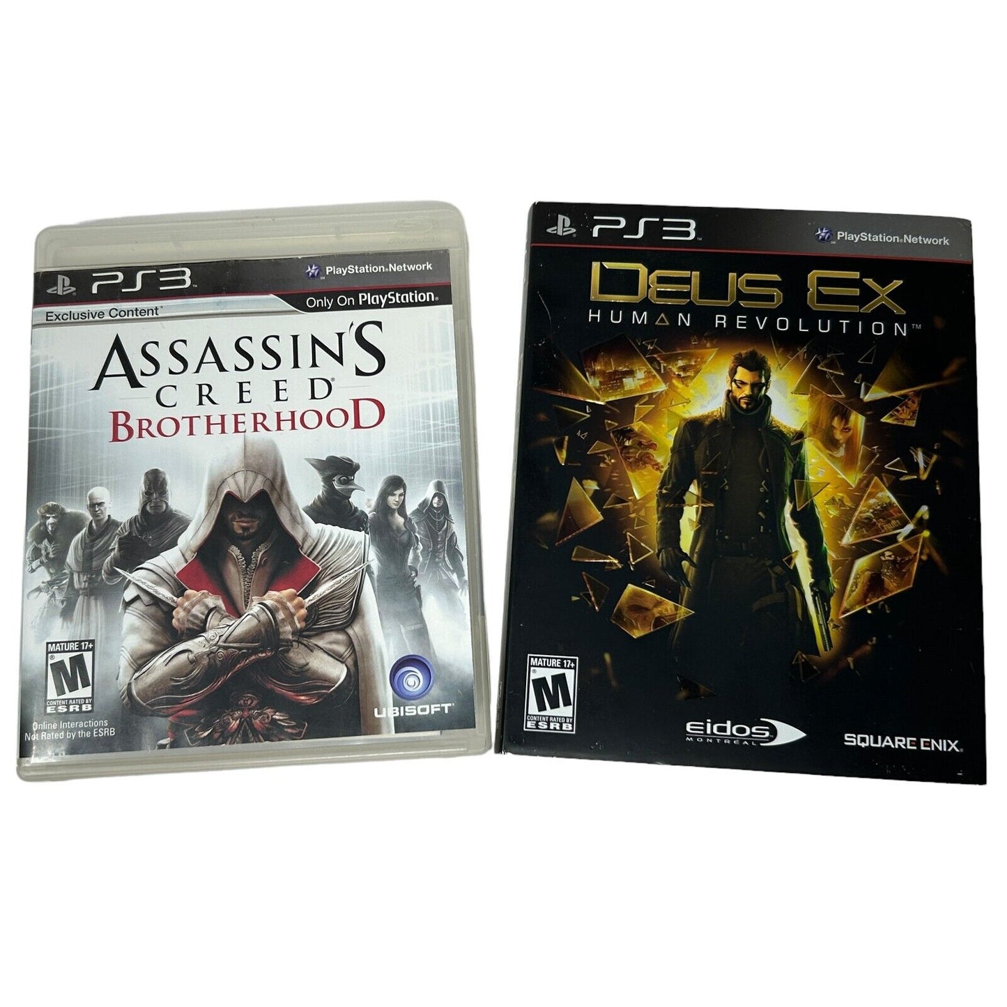 Two PS3 video game cases: Assassin's Creed Brotherhood and Deus Ex Human Revolution with unique artwork