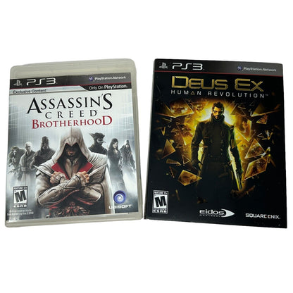 Two PS3 video game cases: Assassin's Creed Brotherhood and Deus Ex Human Revolution with unique artwork