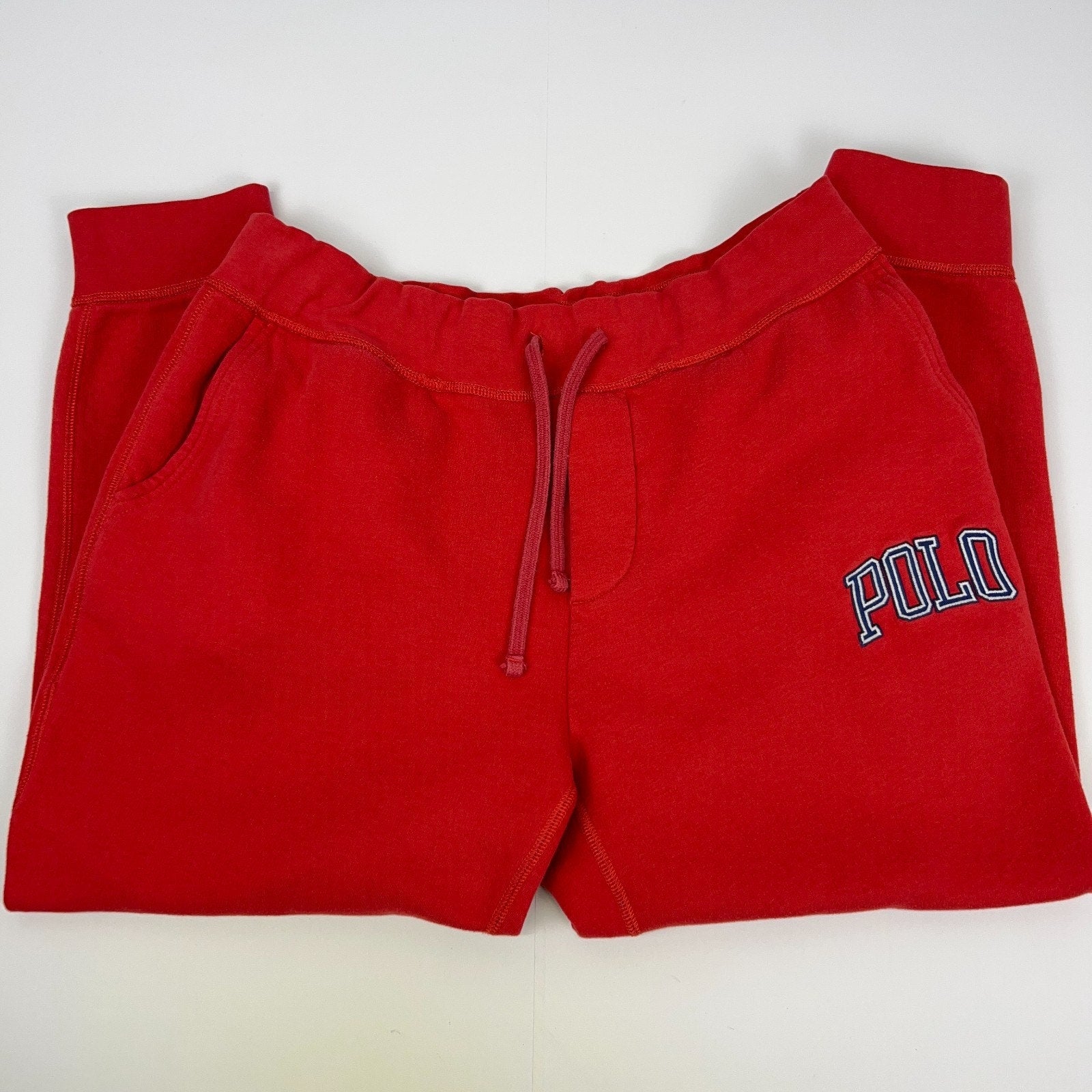 Front view of red Polo Ralph Lauren fleece sweatpants with embroidered logo and drawstring waist