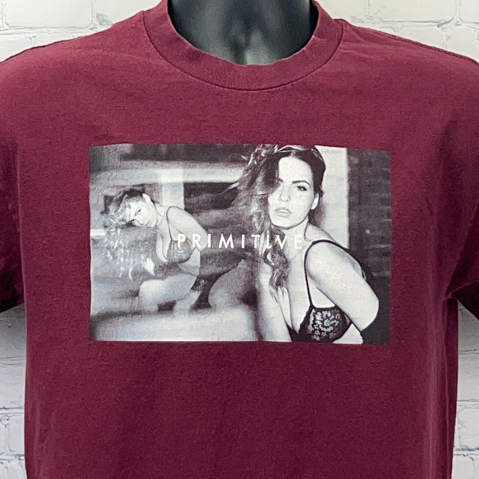Primitive maroon t-shirt featuring a bold graphic print on the front with the word Primitive