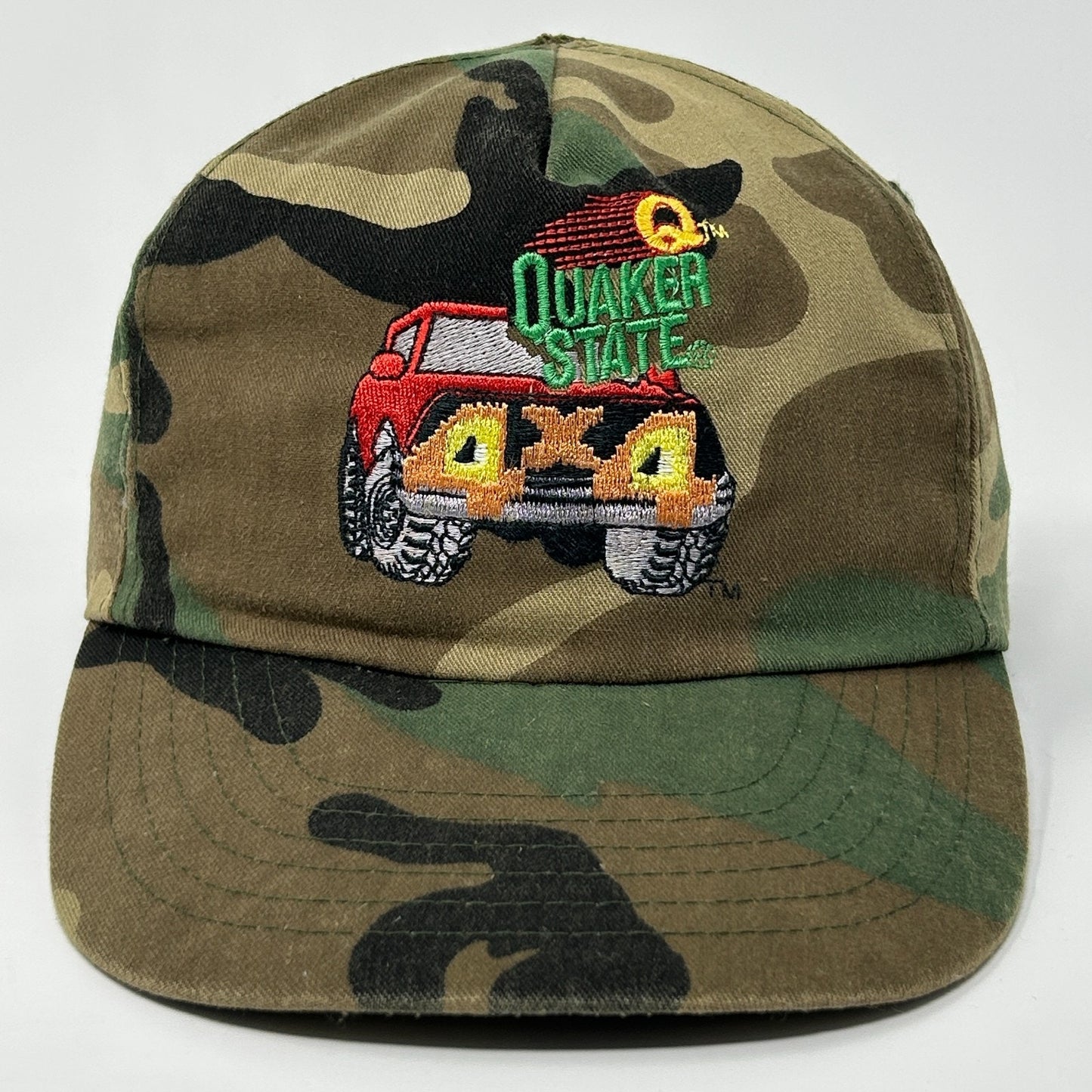 Vintage Hat in camo green featuring embroidered Quaker State logo and red truck design on the front