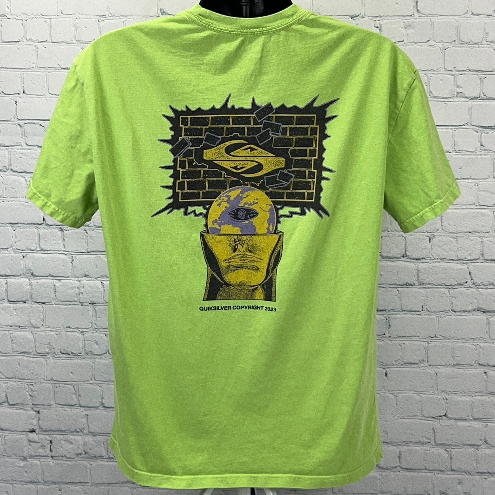 Quiksilver Green Graphic T-Shirt featuring a unique back design with a head and logo