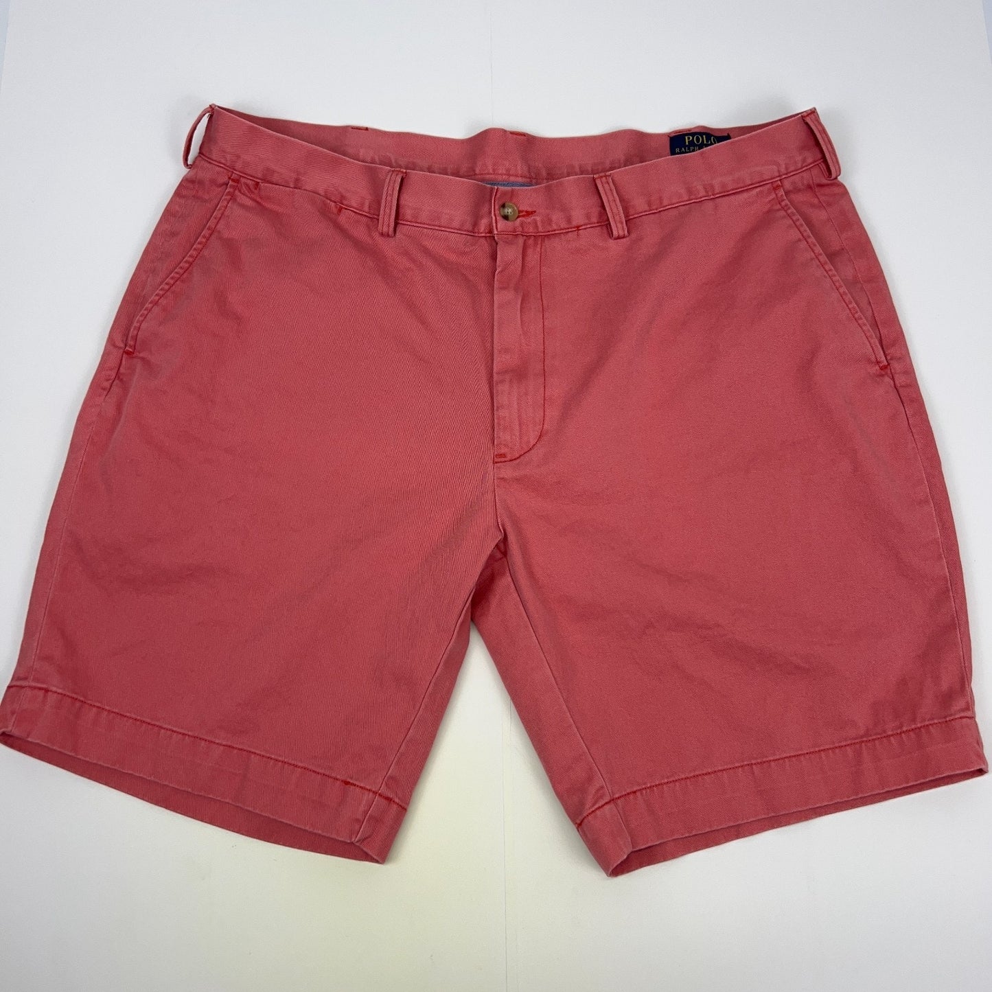 Ralph Lauren coral shorts in size 32 with front view and classic logo detailing