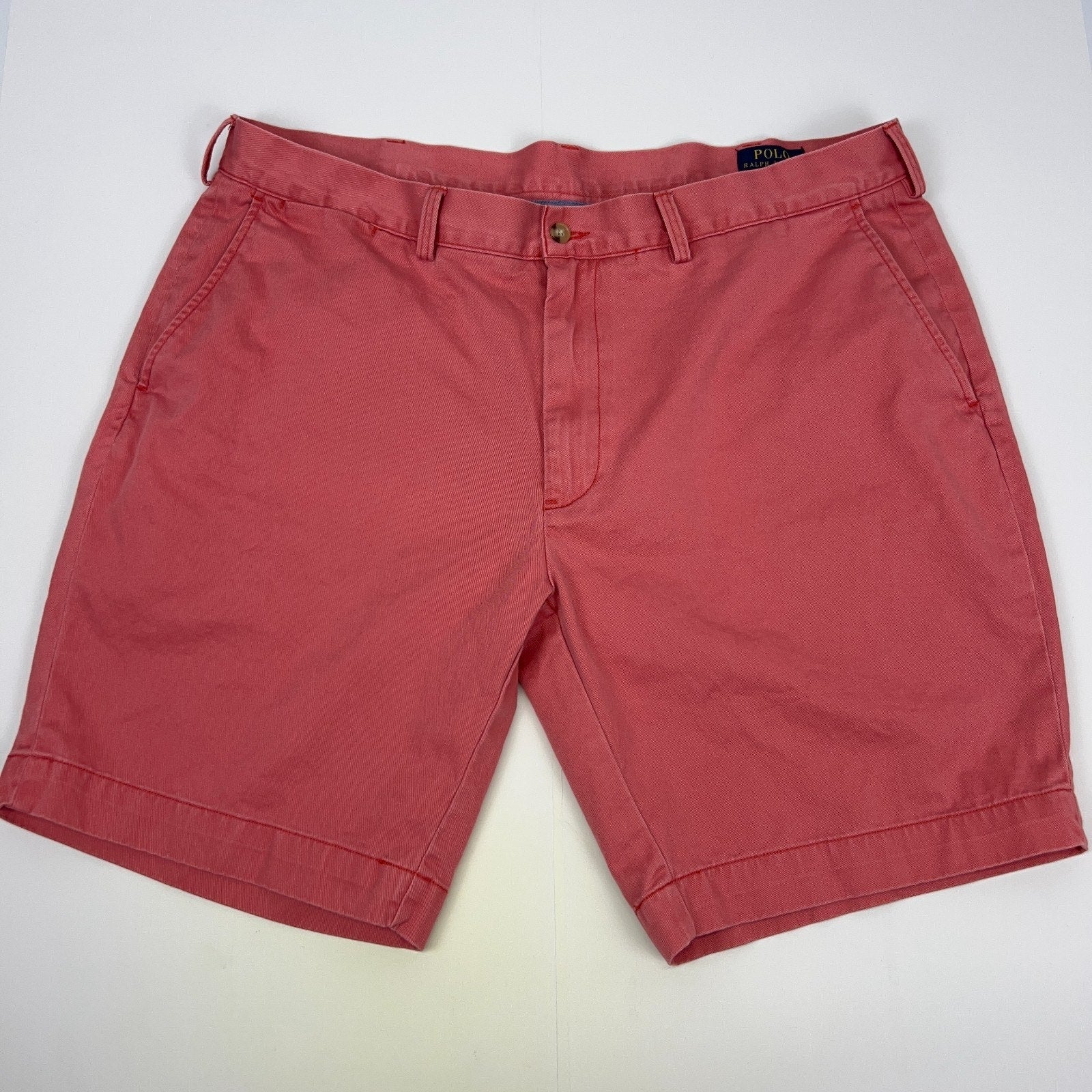 Ralph Lauren coral shorts in size 32 with front view and classic logo detailing