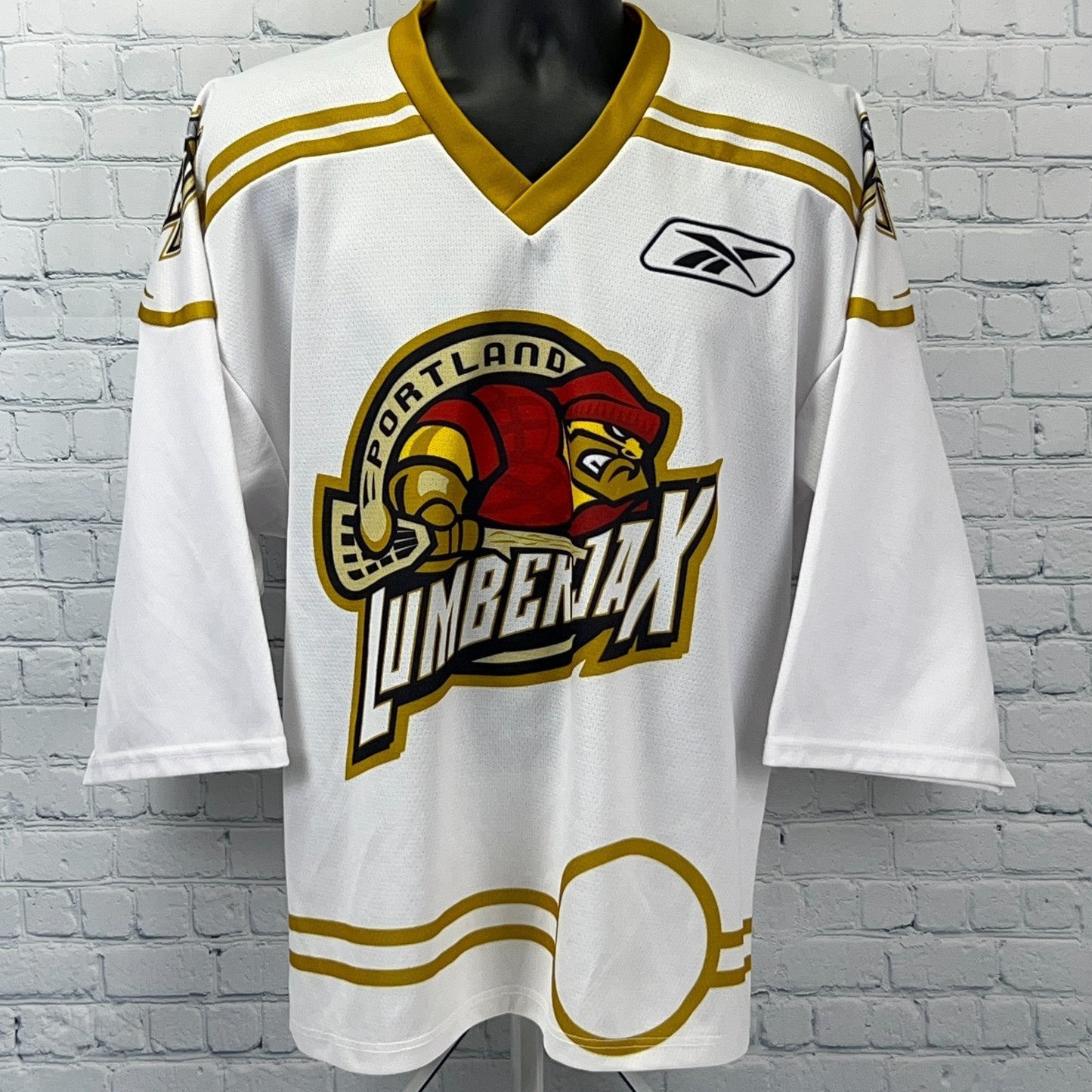 Front view of the Reebok NLL Jersey in white with Portland LumberJax logo and gold accents