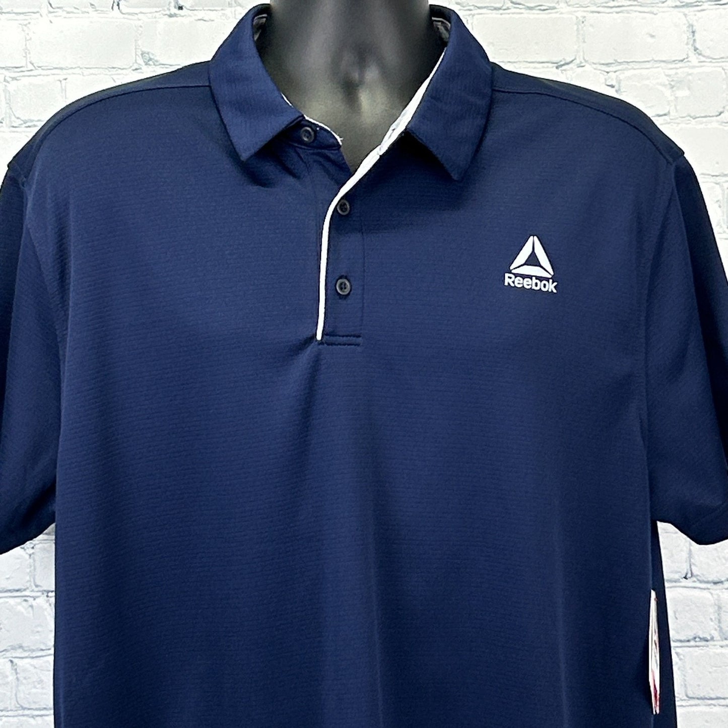 Reebok Polo in navy blue with a standard fit and logo on the chest, front view