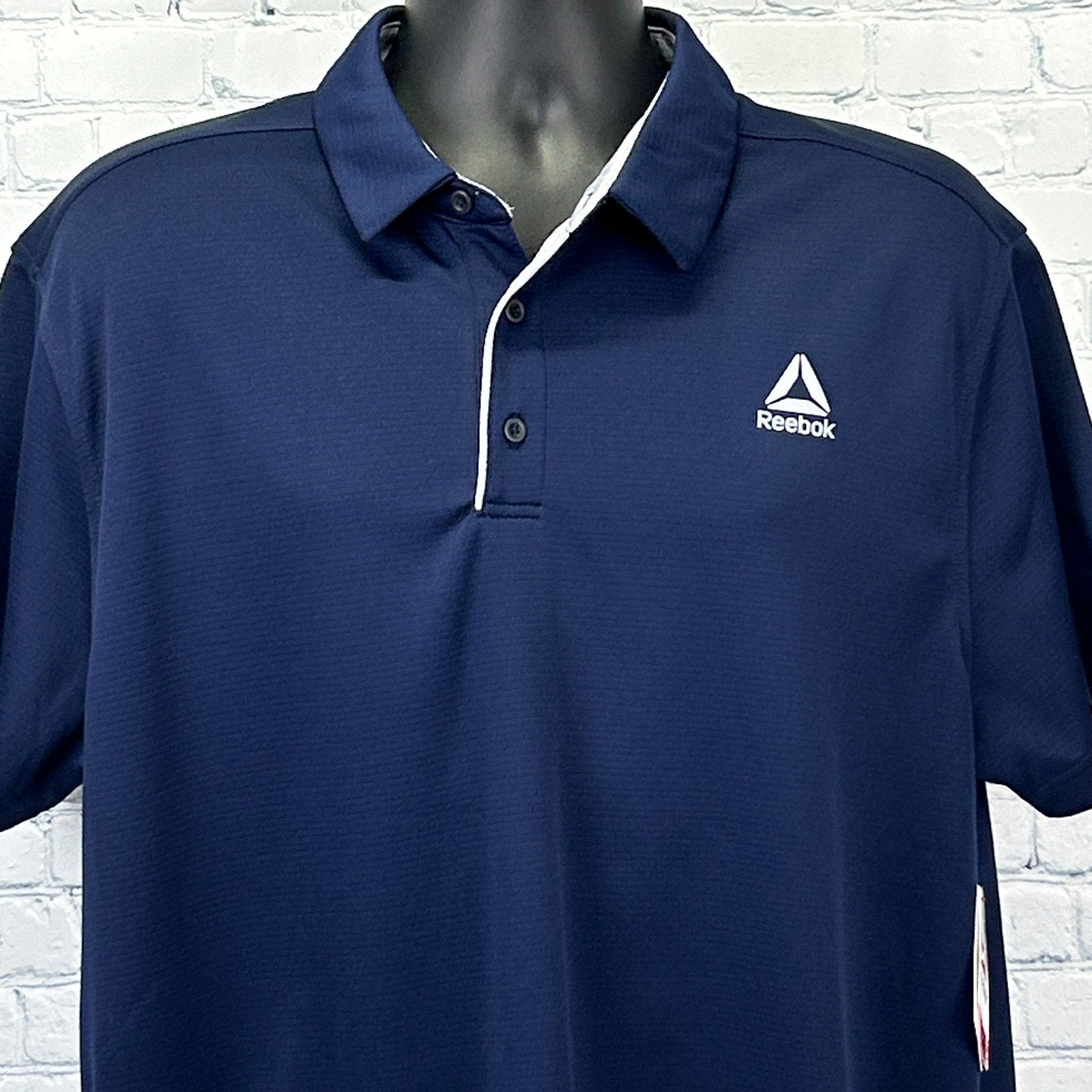 Reebok Polo in navy blue with a standard fit and logo on the chest, front view