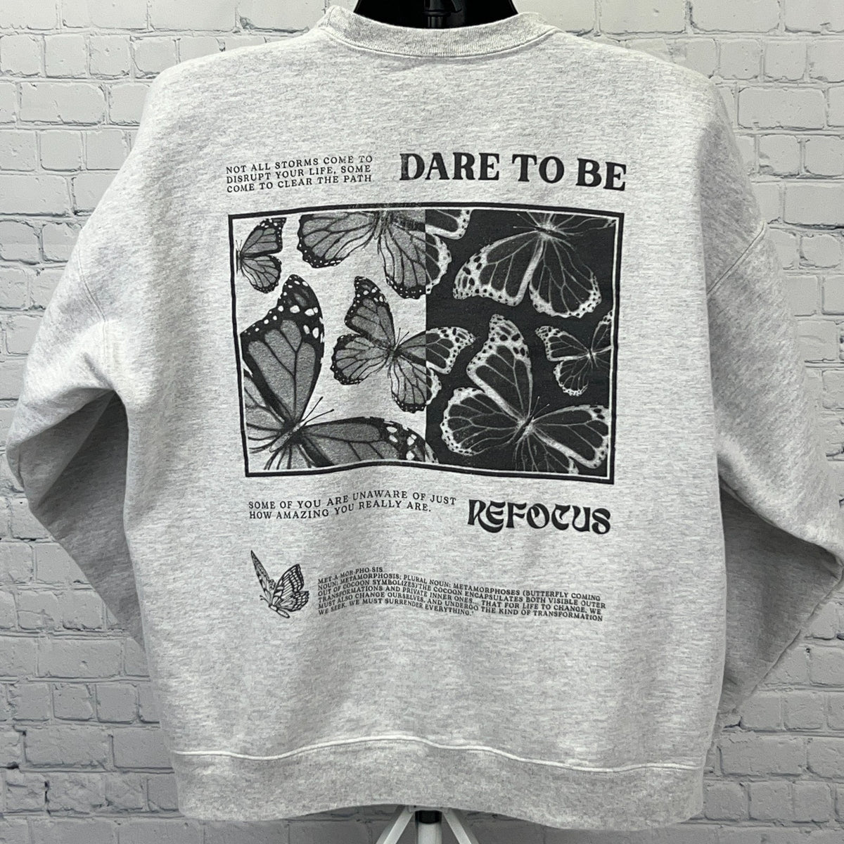 Gray KK Fit sweatshirt featuring butterfly graphics and inspirational text on the back