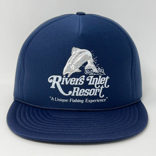 Navy blue vintage baseball cap with Rivers Inlet Resort logo featuring a jumping fish in front view