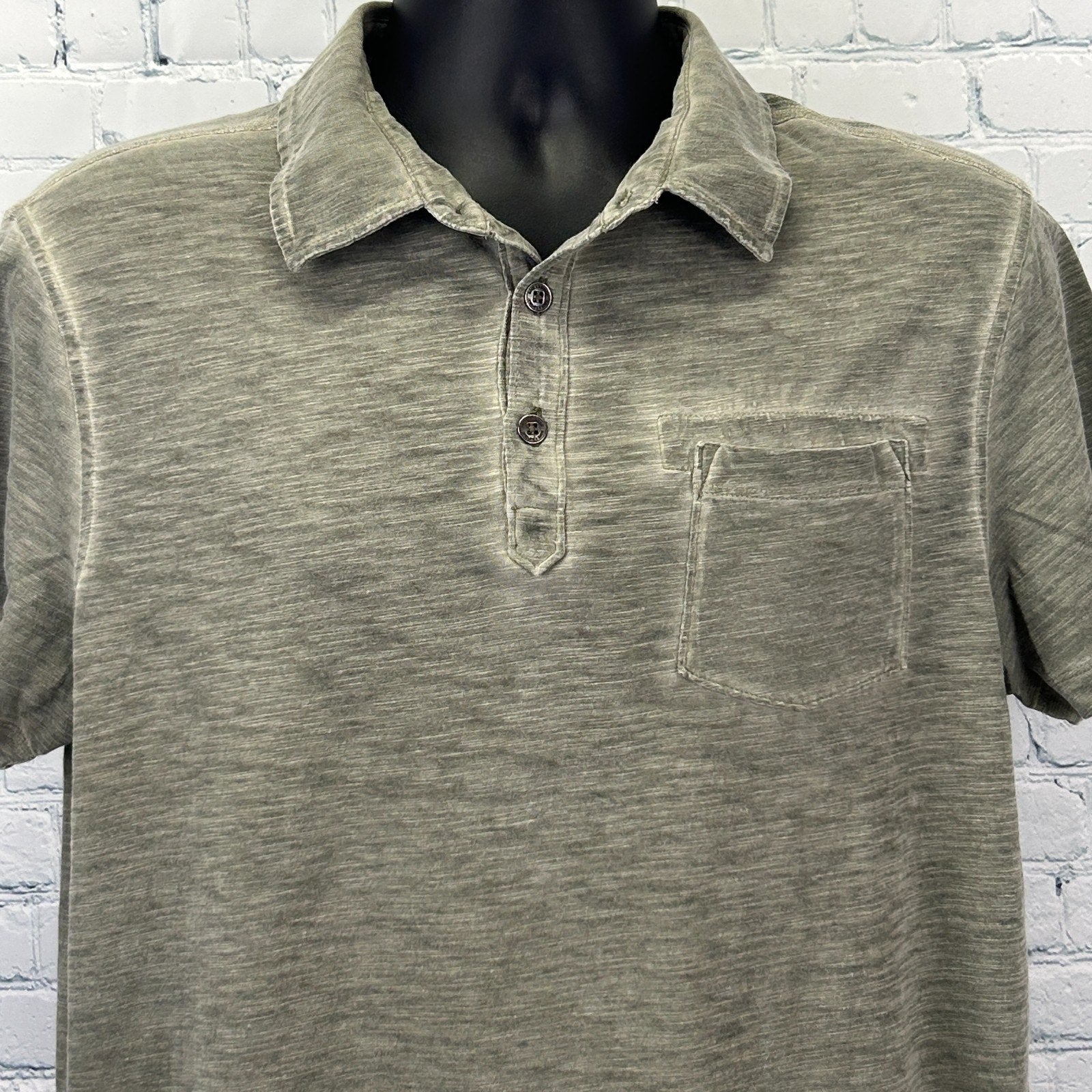 Rock & Republic Polo in olive green, featuring a front pocket and button collar, viewed from the front