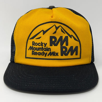 Vintage Trucker Hat in yellow and black featuring Rocky Mountain Ready Mix logo on the front
