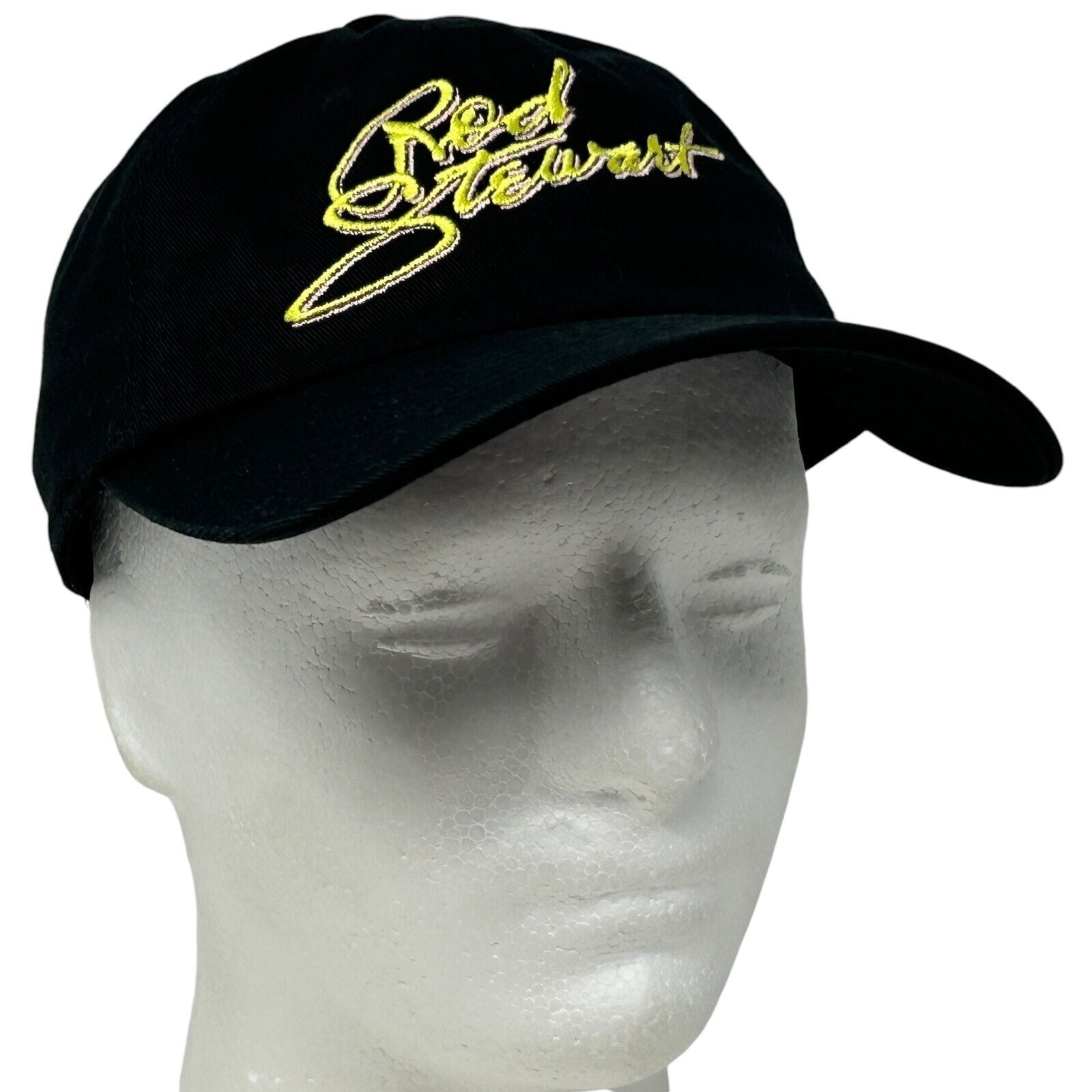 Black Nissi Caps baseball hat featuring embroidered Rod Stewart logo, worn on a mannequin head