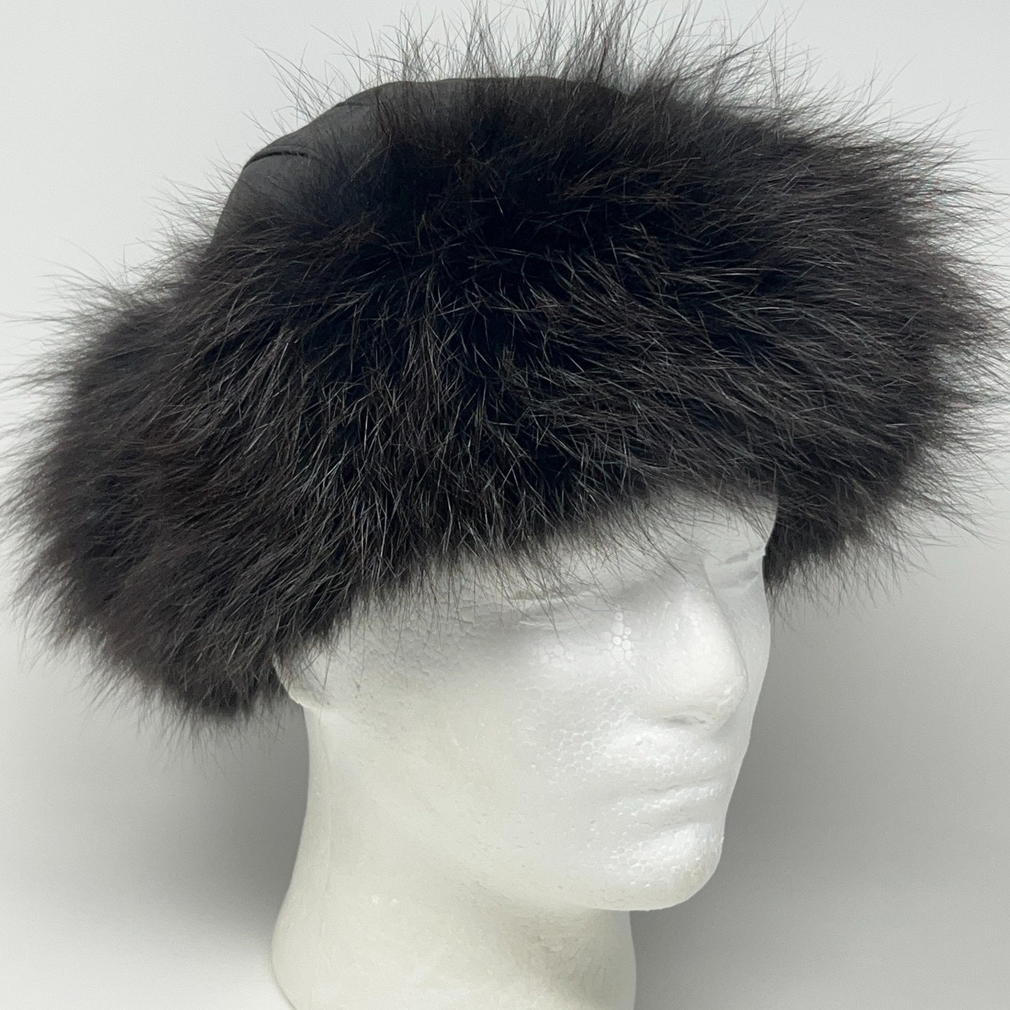 Vintage Roller Hat in black with fluffy fur detail, showcasing a front view on a mannequin head