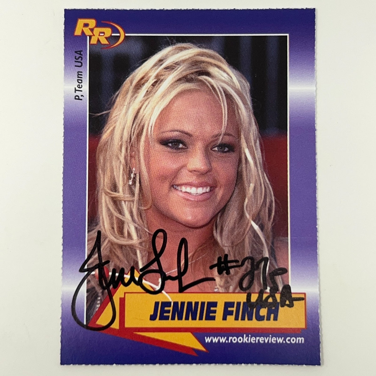 Rookie Review signed photo card of Jennie Finch featuring her smiling with blonde hair, purple design and unique logo