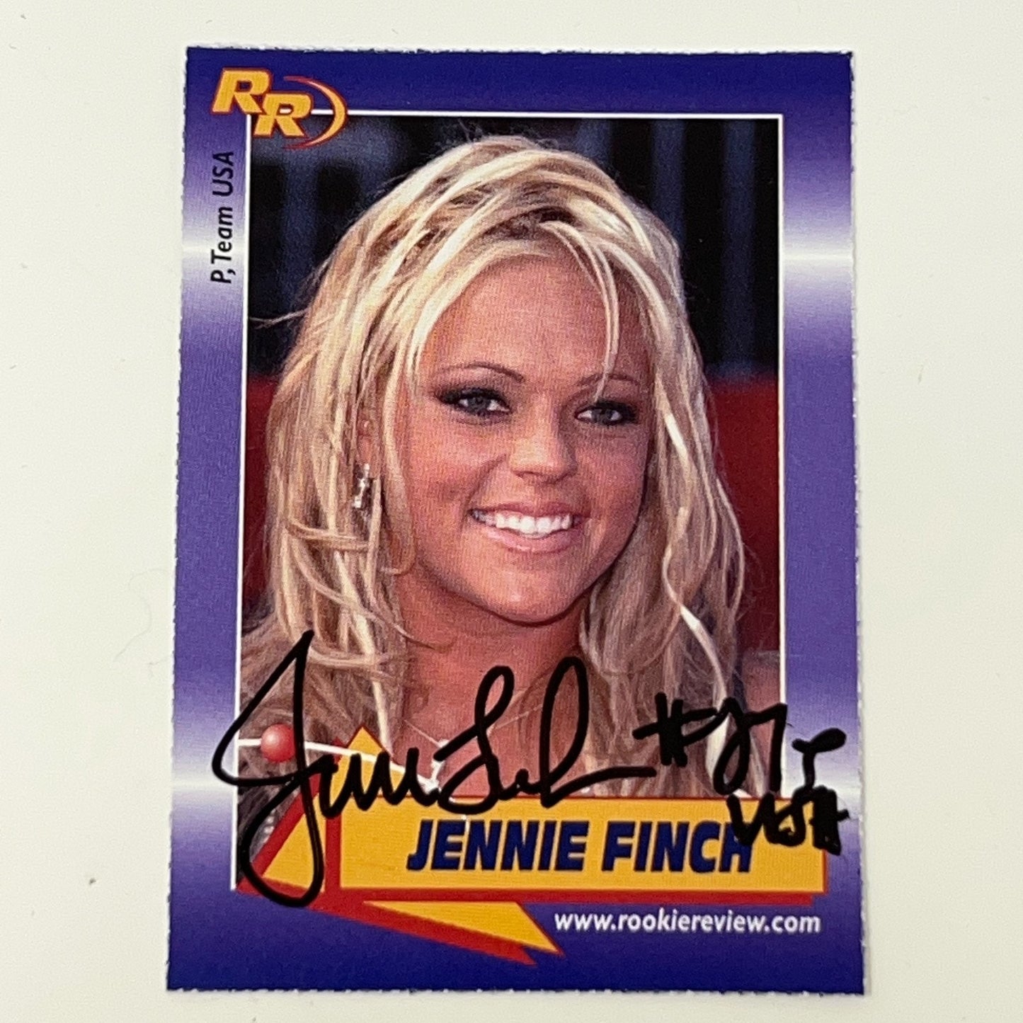 Rookie Review signed card featuring Jennie Finch, with a close-up image of her smiling on a purple background