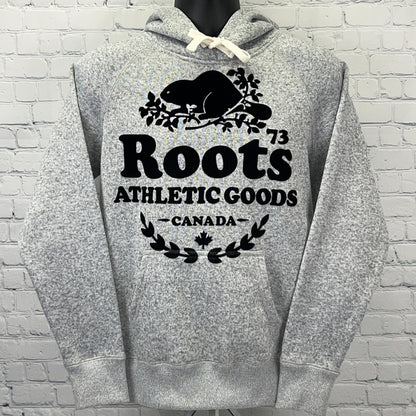 Front view of gray Roots hoodie featuring bold logo, beaver design, and drawstring hood