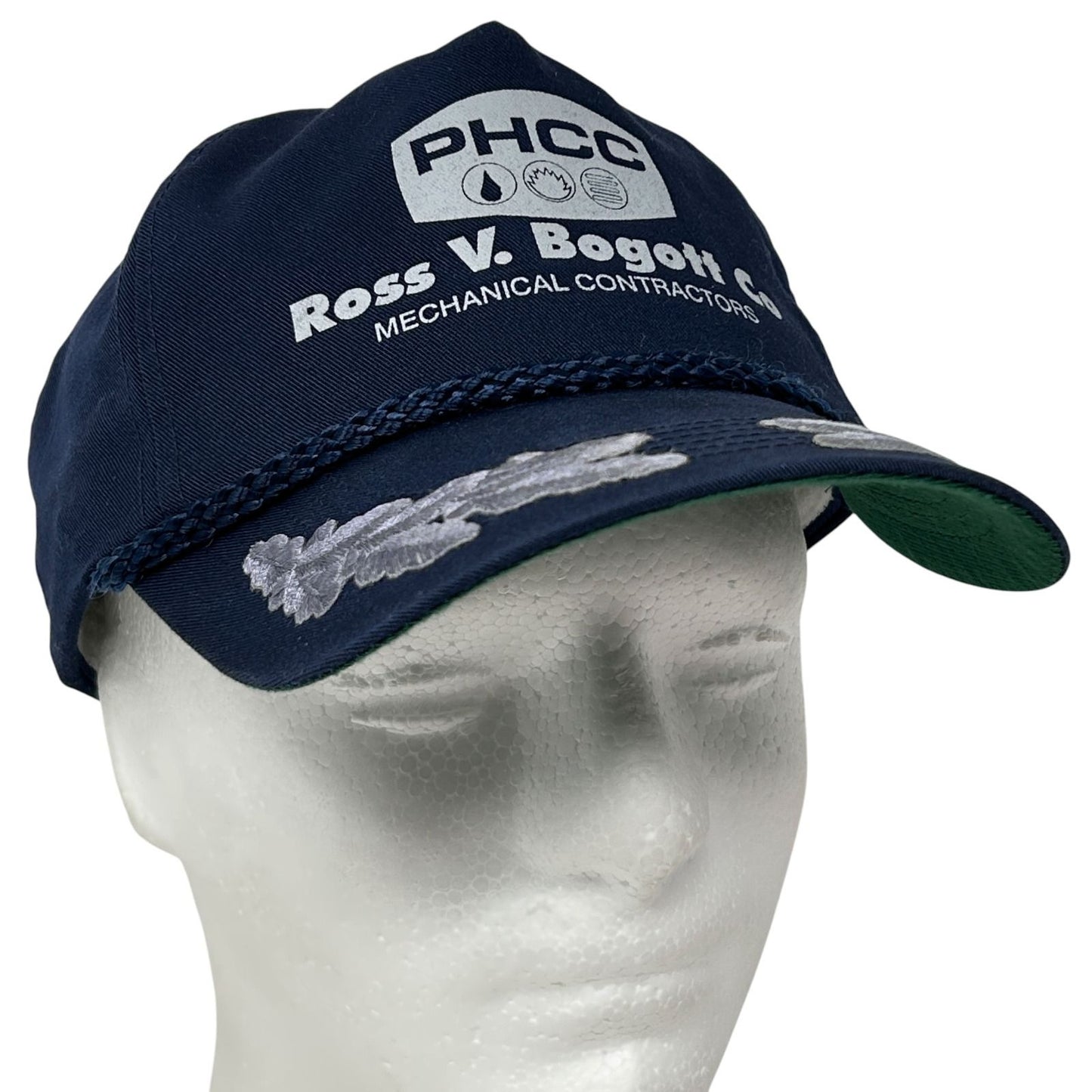 Navy blue vintage hat with PHCC Mechanical Contractors logo and braided detail on the front view