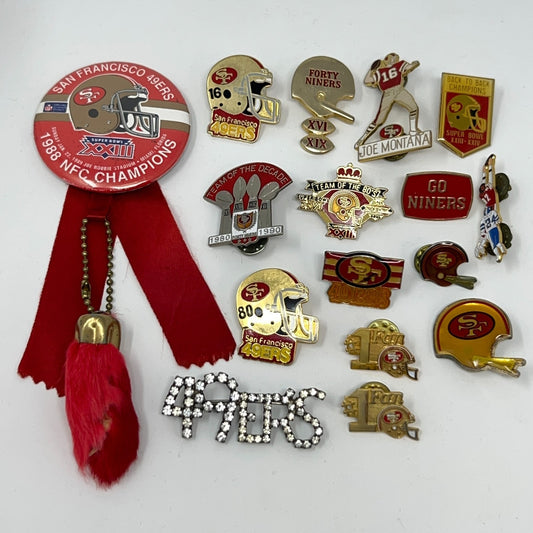 Collection of San Francisco 49ers pins and memorabilia with various designs in gold and red colors