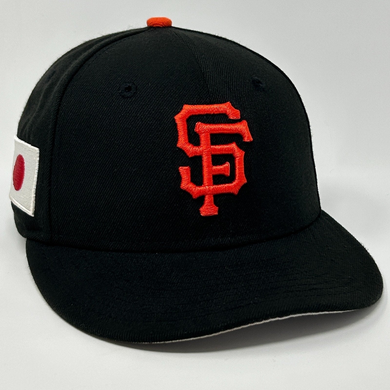 New Era San Francisco Giants Black Baseball Cap with Orange Logo and Side Flag Detail