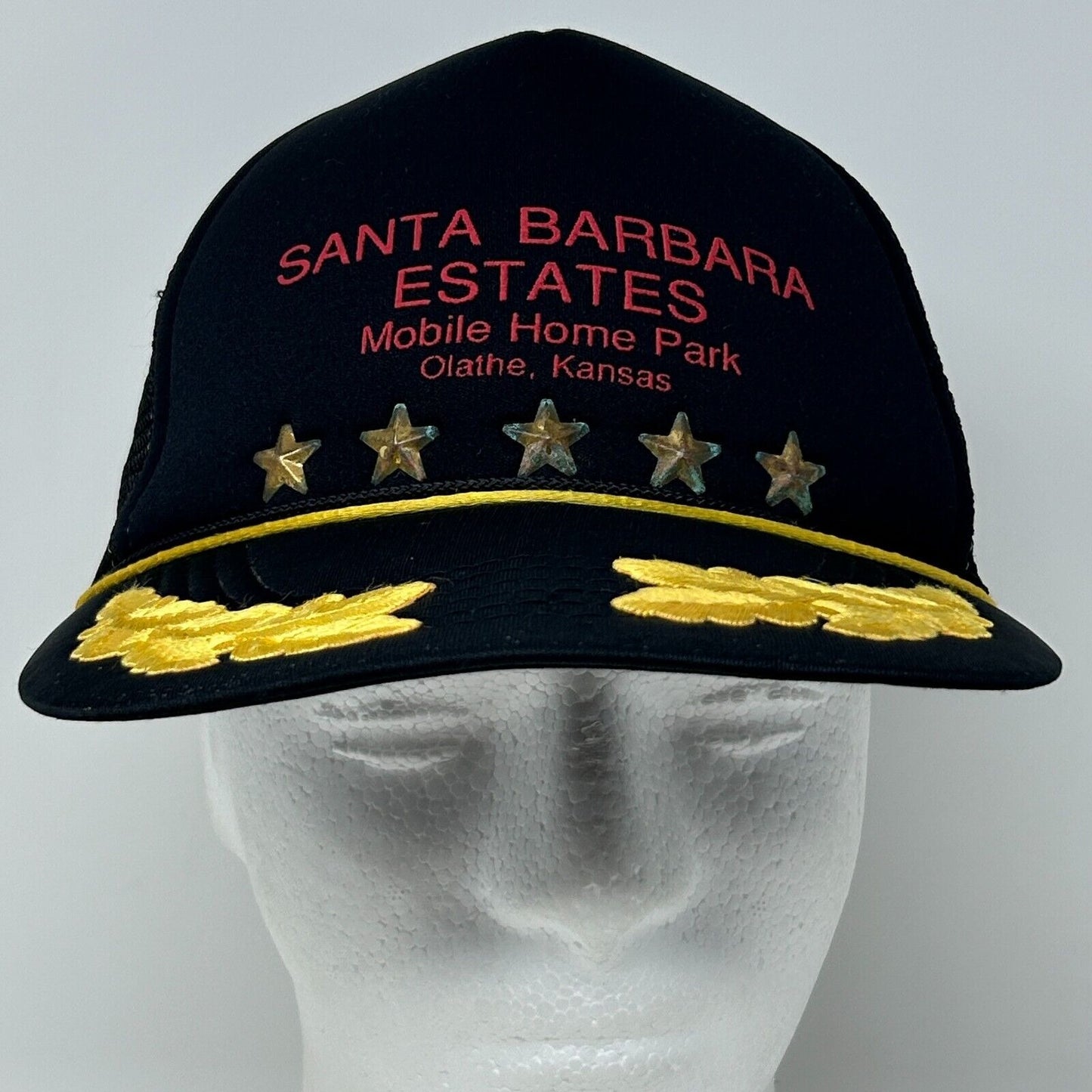 Black Vintage Hat with Santa Barbara Estates Mobile Home Park logo and gold star accents on the front