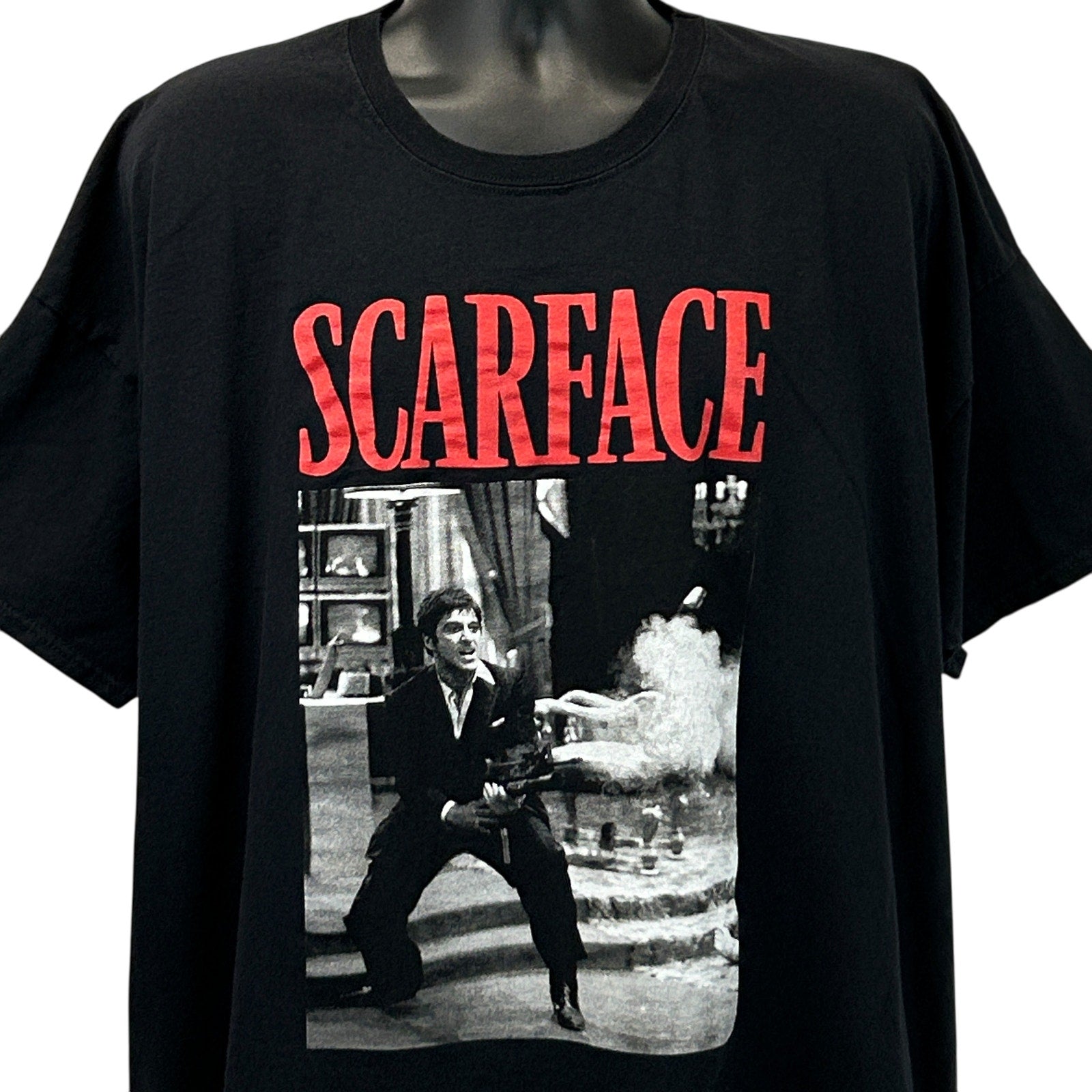 Front view of black boohooMAN Scarface t-shirt featuring a graphic print of a scene from the movie
