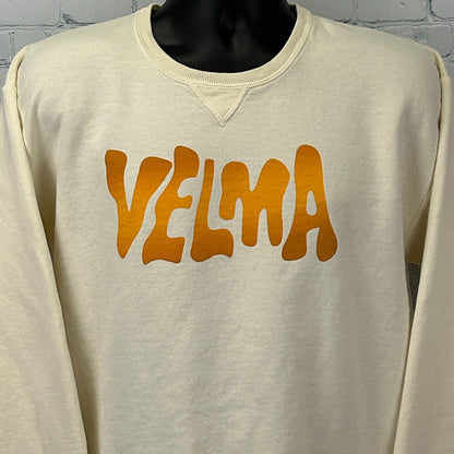 Cream Scooby Doo Sweatshirt featuring a bold orange 'VELMA' graphic on the front