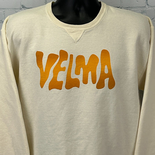 Cream Scooby Doo Sweatshirt featuring a bold orange 'VELMA' graphic on the front