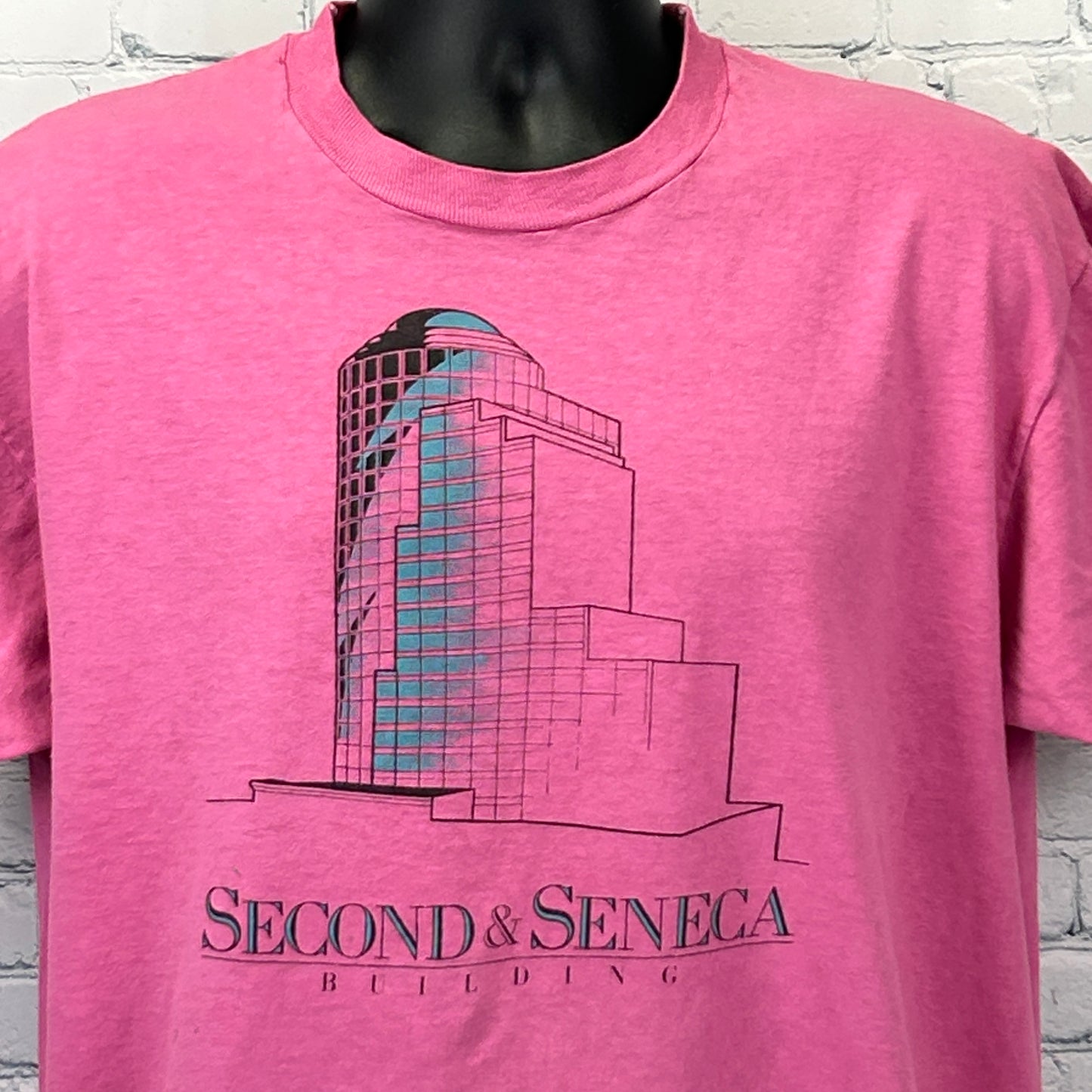 Vintage pink Seattle T-shirt featuring Second and Seneca Building graphic on front