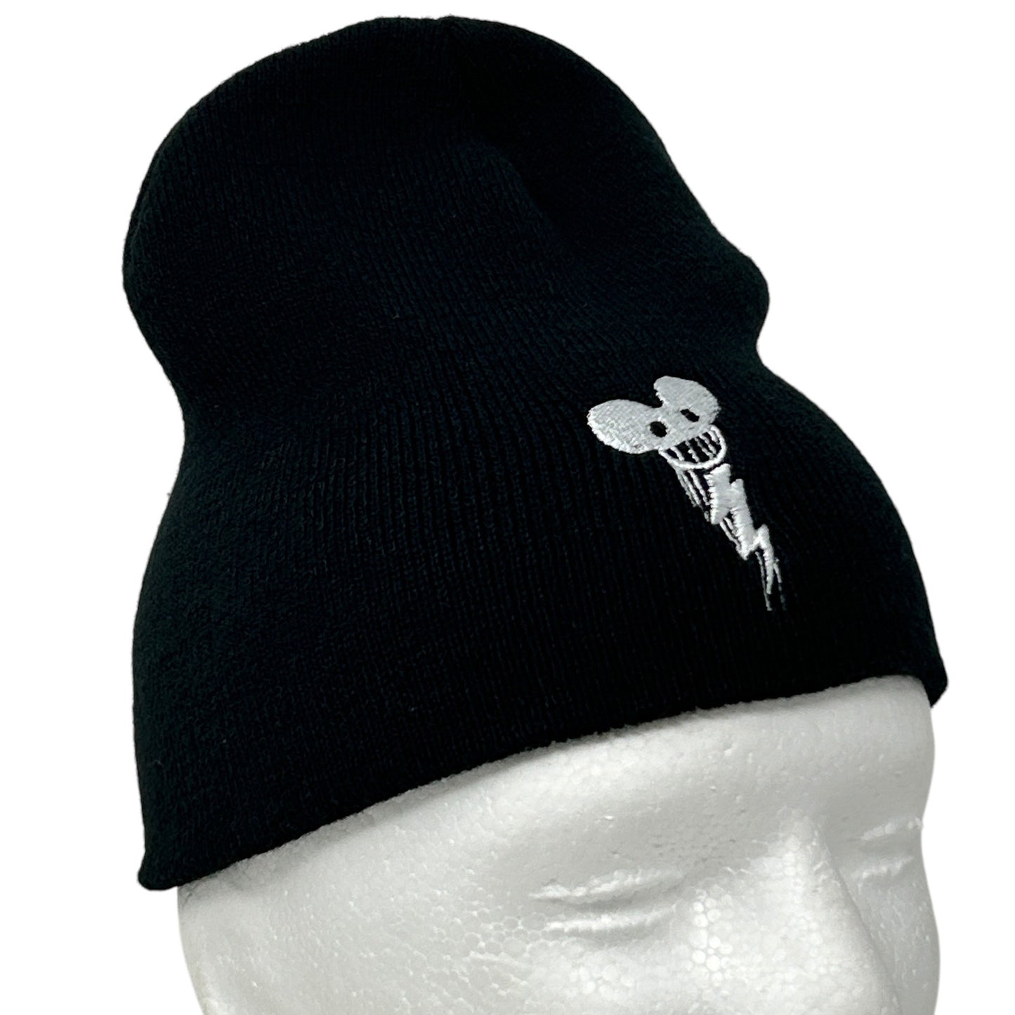 Black beanie hat featuring a white skeleton mouse logo on the side, view from the side