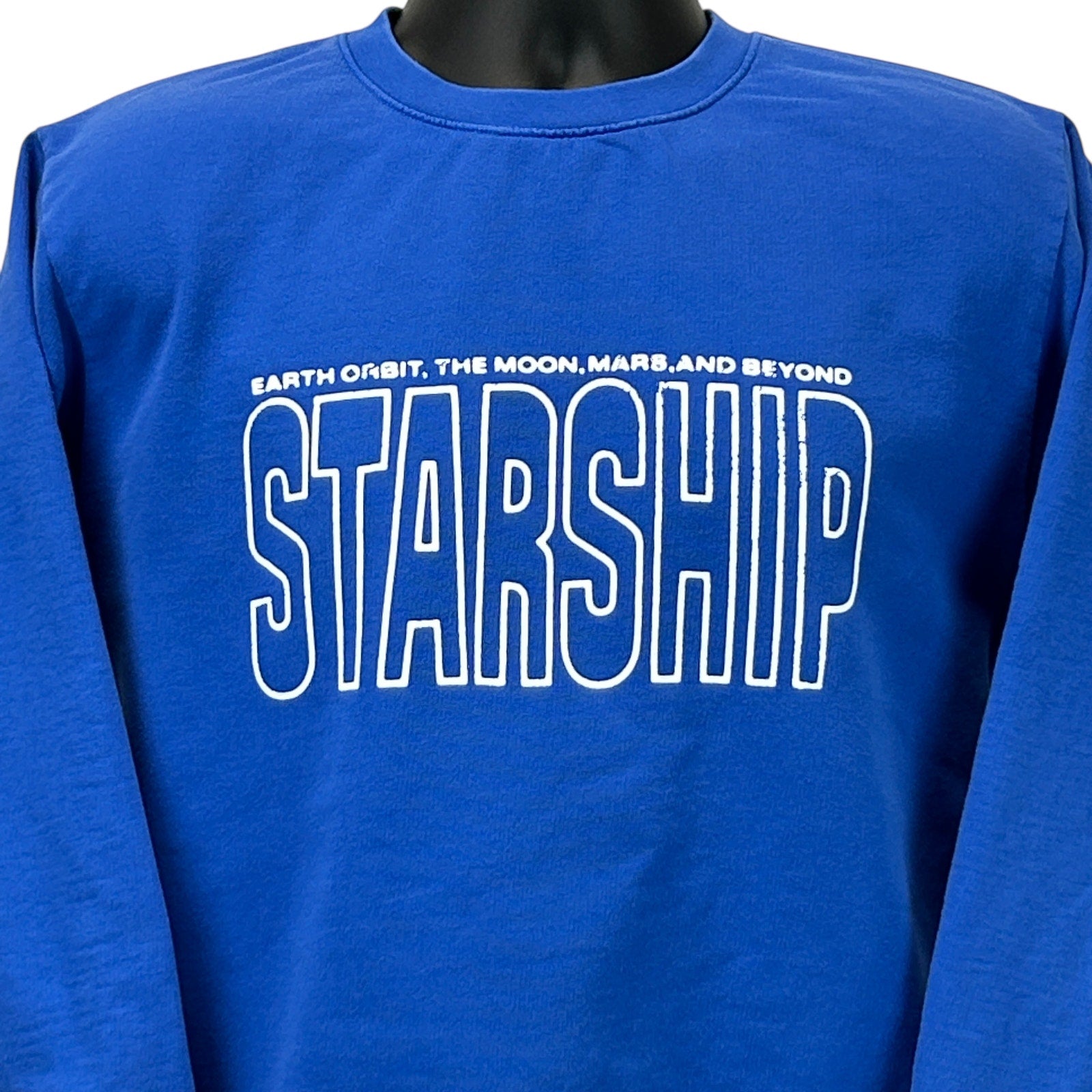 Blue SpaceX Starship sweatshirt featuring bold 'STARSHIP' text with Earth, moon, and Mars design on the front