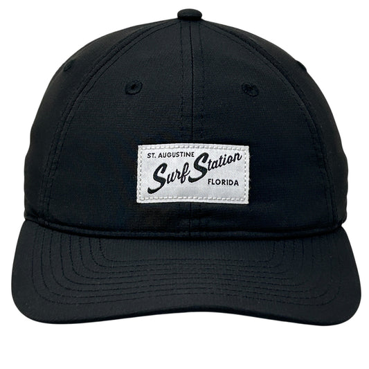 Black adjustable Surf Station cap with front logo patch from St. Augustine, Florida