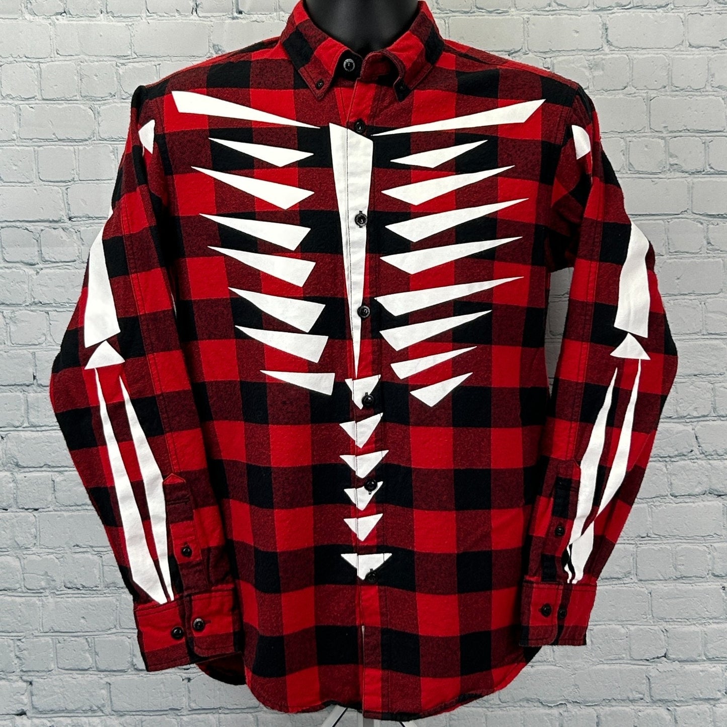 Front view of red and black checkered Staple Pigeon Shirt with white bone graphic design and logo details