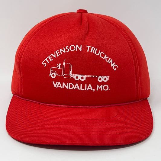 Front view of red Trucker Hat with Stevenson Trucking logo from Vandalia, MO