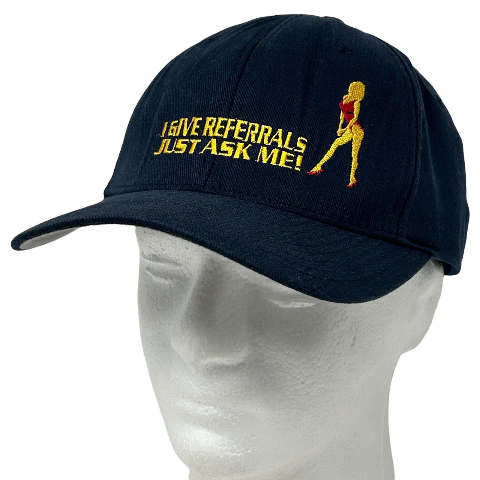 Black Flexfit hat featuring yellow 'I GIVE REFERRALS JUST ASK ME!' text and a dancer graphic
