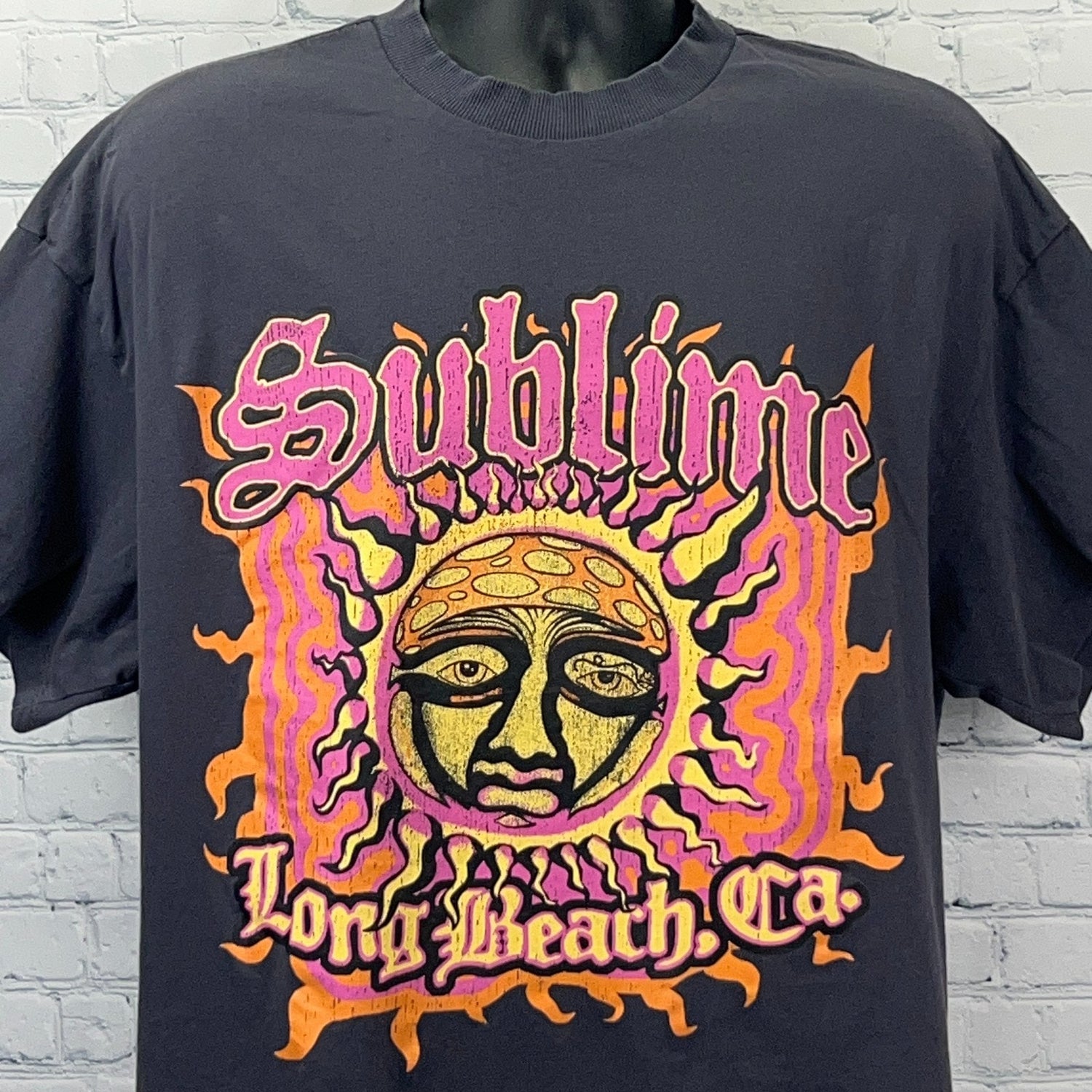Front view of Divided by H&M black Sublime graphic t-shirt featuring vibrant sun design and Long Beach text