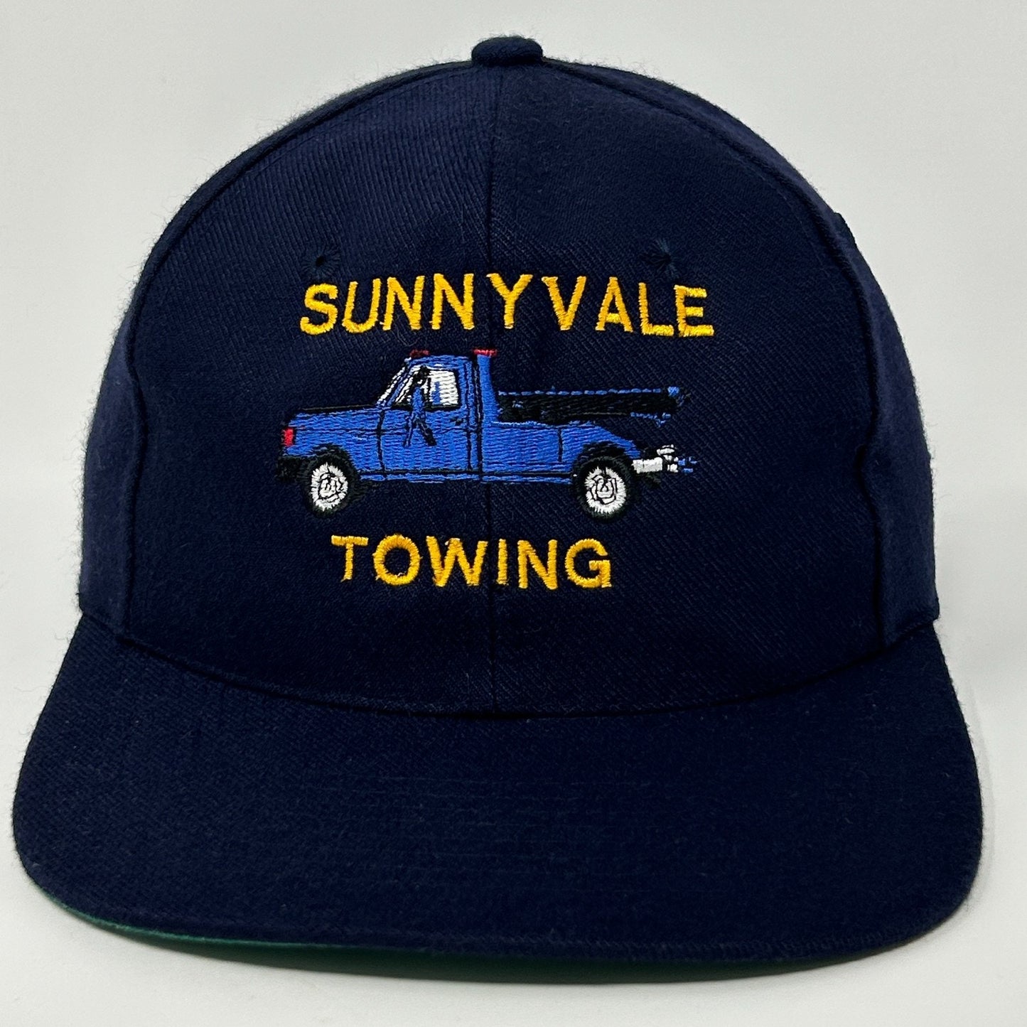 Navy Vintage Baseball Cap Hat featuring SUNNYVALE TOWING logo with blue truck embroidery on the front