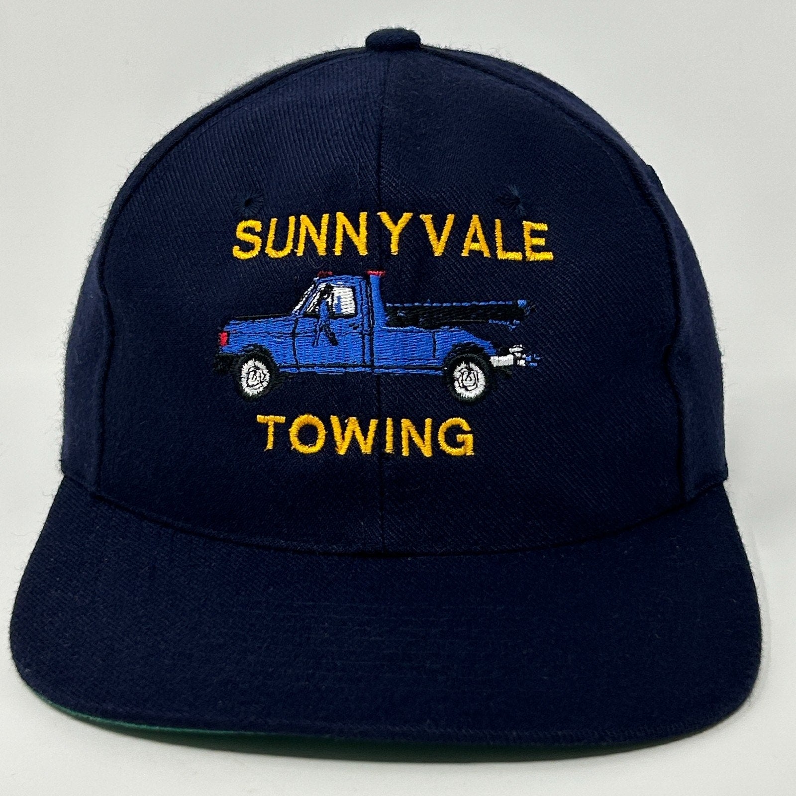 Navy Vintage Baseball Cap Hat featuring SUNNYVALE TOWING logo with blue truck embroidery on the front