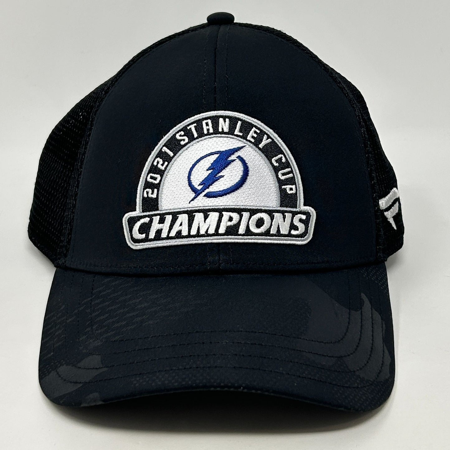 Front view of black Tampa Bay Lightning hat featuring 2021 Stanley Cup Champions logo and mesh back