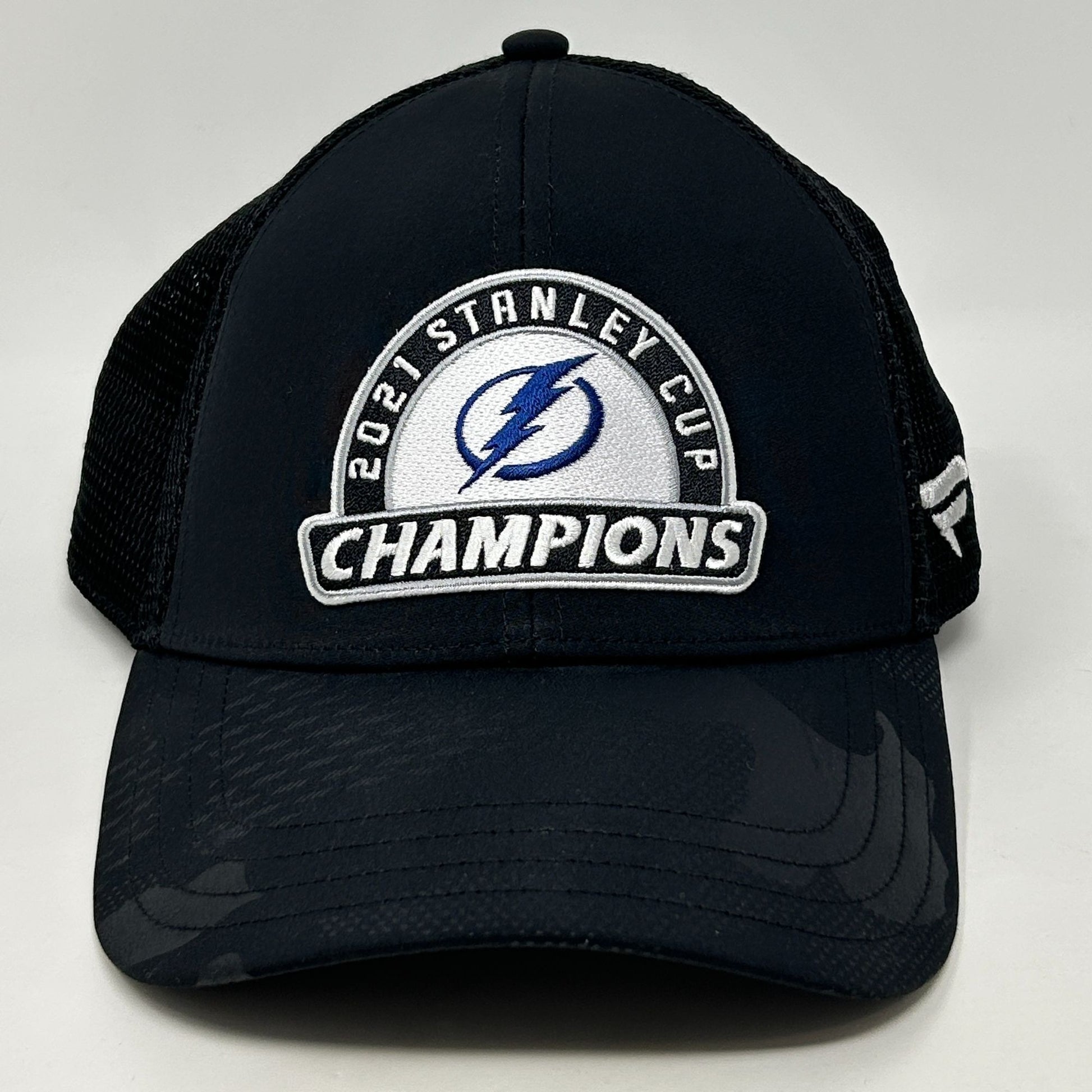 Front view of black Tampa Bay Lightning hat featuring 2021 Stanley Cup Champions logo and mesh back