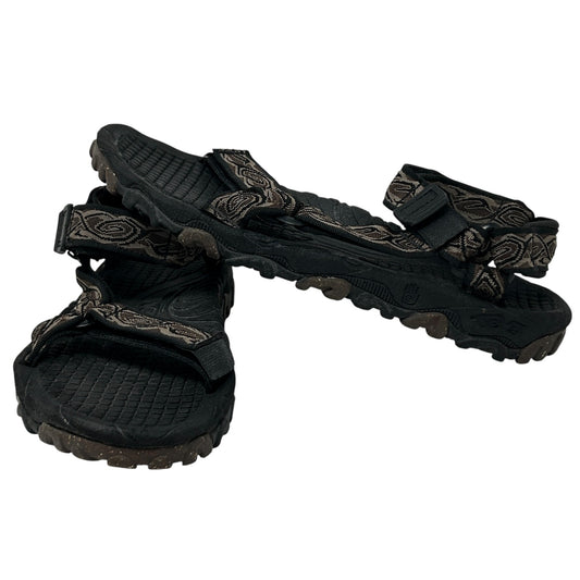 Teva Sandals in black with patterned straps, showcasing a front view and rugged sole for durability.