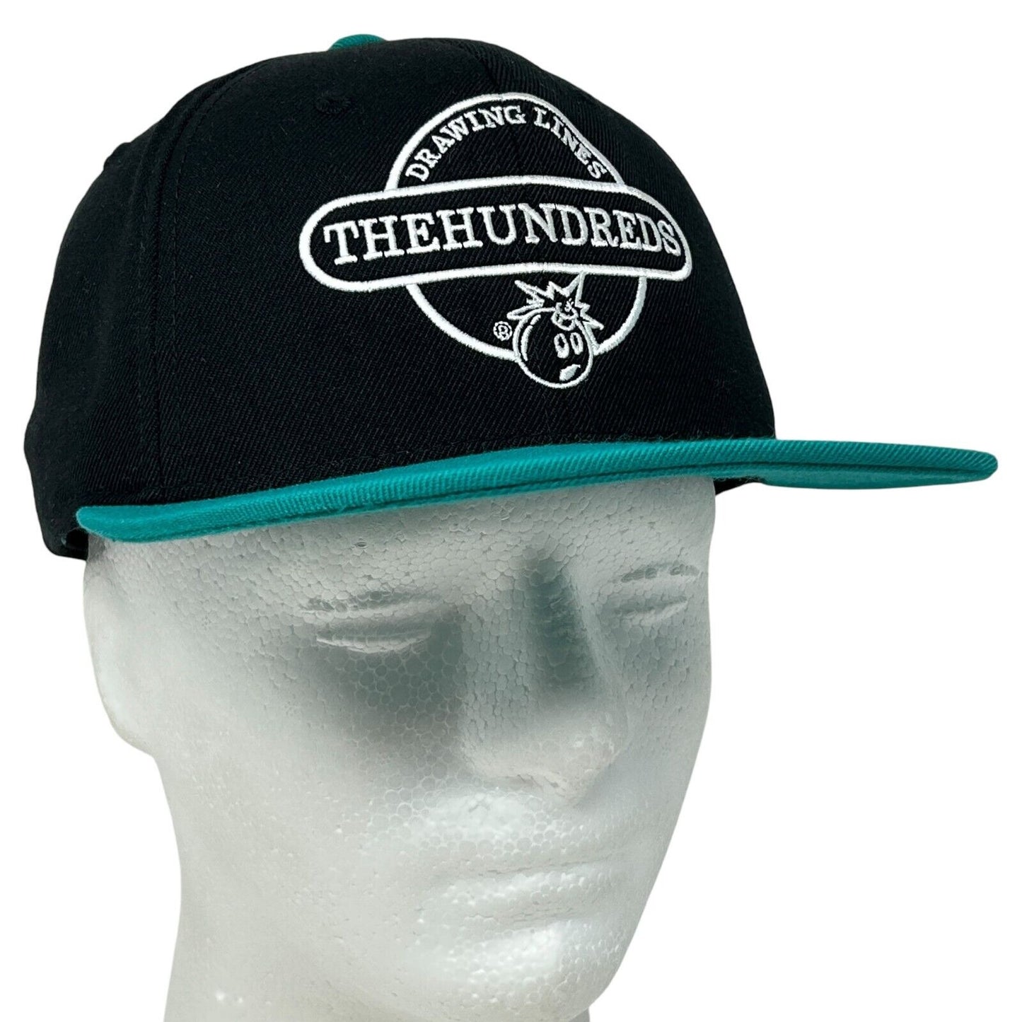 Front view of The Hundreds black cap with turquoise brim and logo detailing