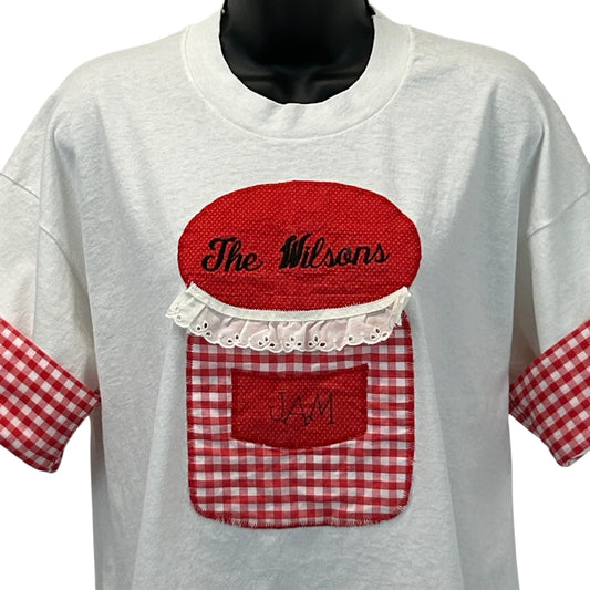 White Fruit of the Loom T-Shirt with red gingham sleeves featuring The Wilson's Jam embroidered logo on the front