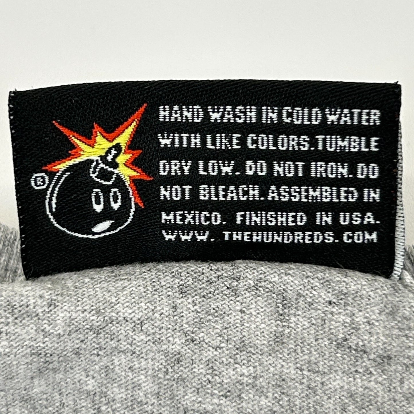 The Hundreds streetwear graphic t shirt in gray, front view with care label detail