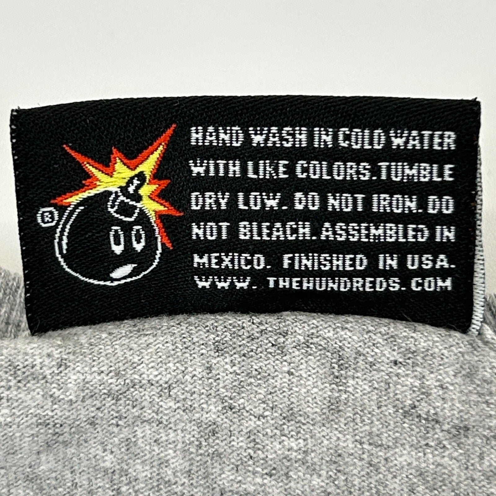 The Hundreds streetwear graphic t shirt in gray, front view with care label detail
