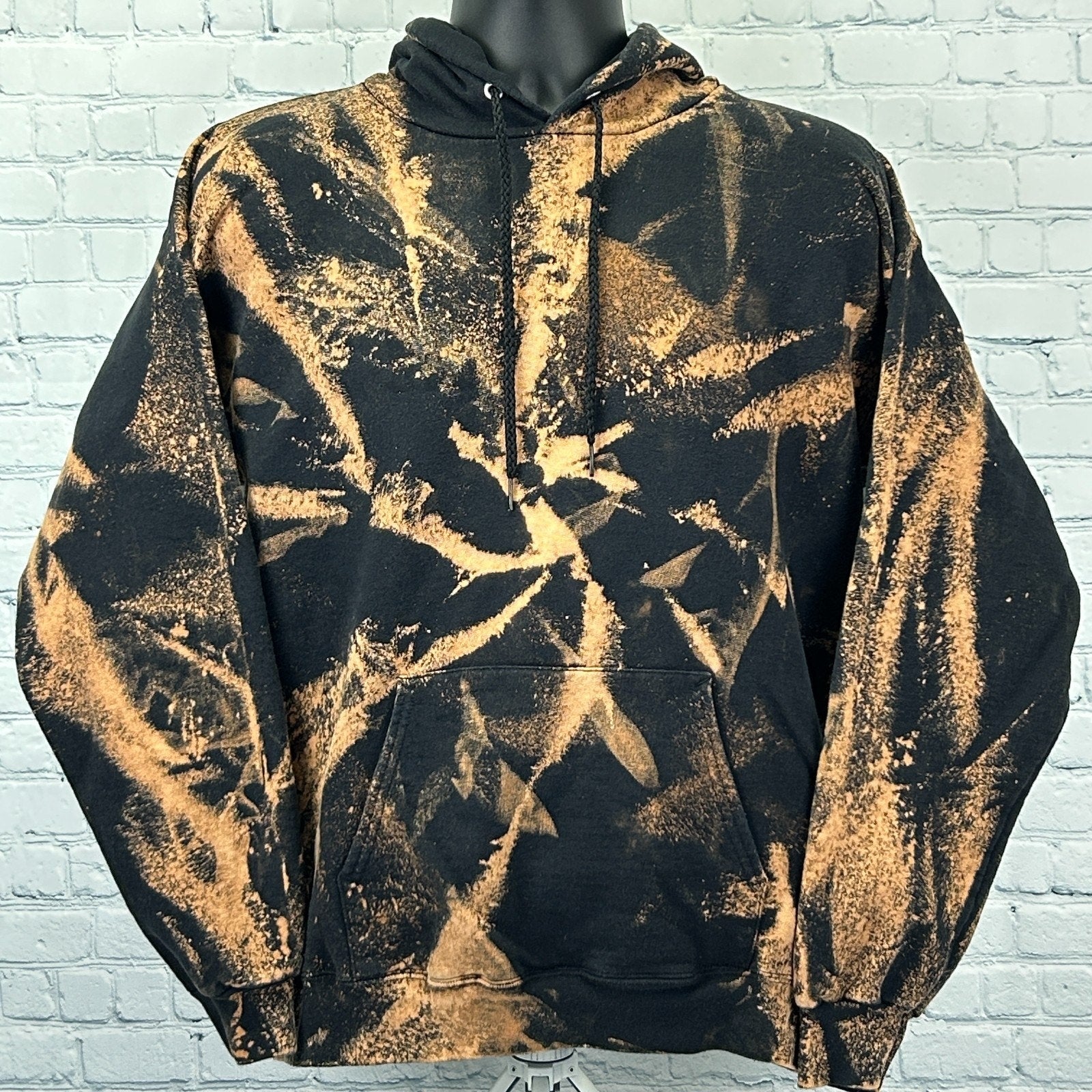 Hanes Tie Dye Hoodie in black and orange with a front view, featuring a unique abstract pattern