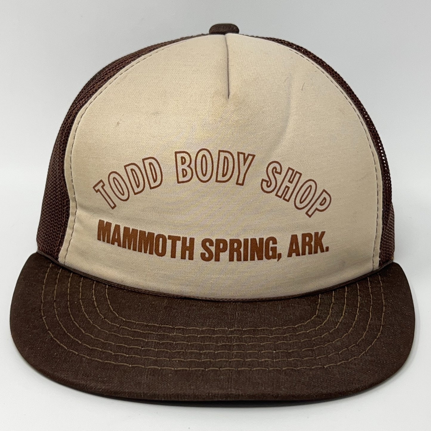 Brown and beige Trucker Hat featuring Todd Body Shop logo from Mammoth Spring, AR, view from the front