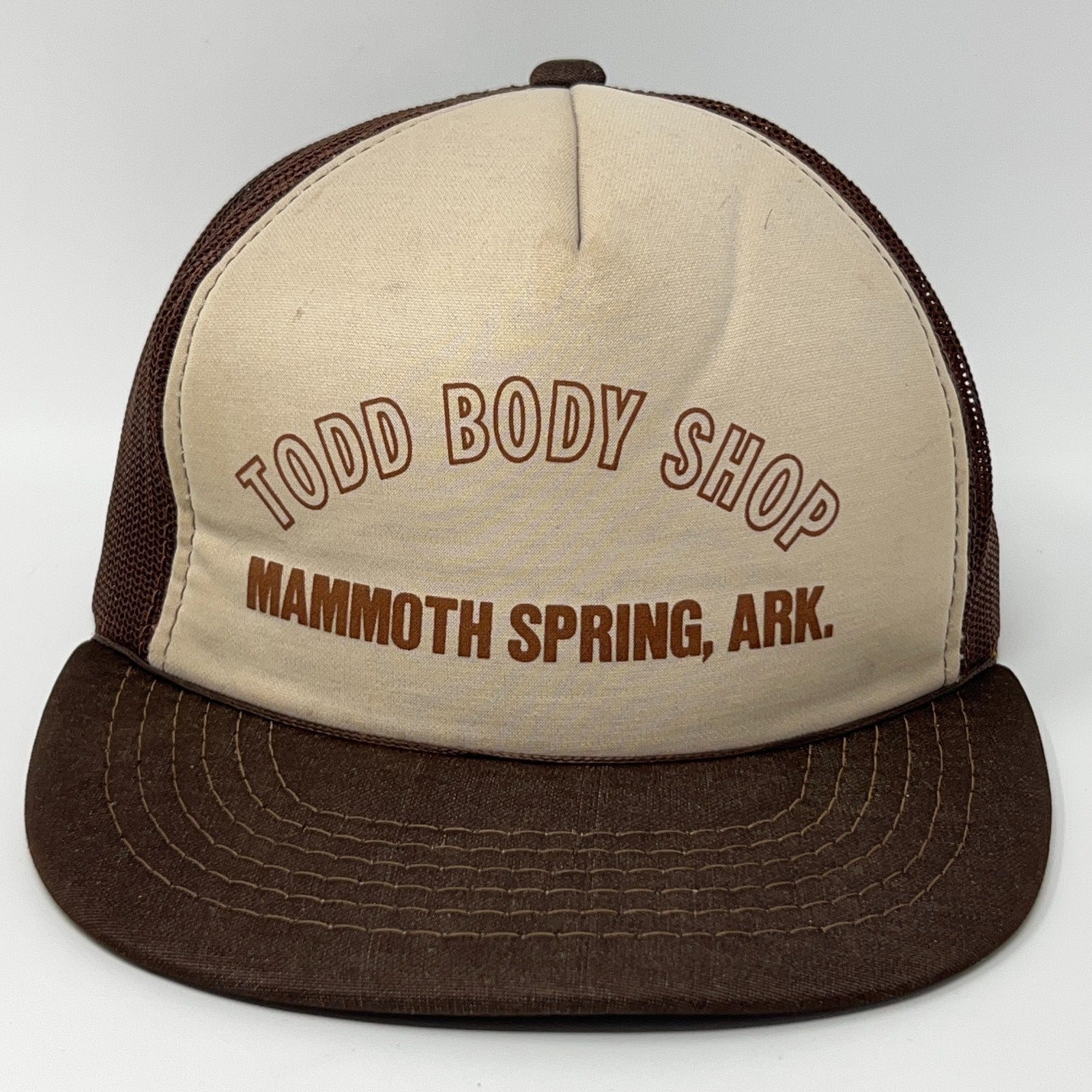 Brown and beige Trucker Hat featuring Todd Body Shop logo from Mammoth Spring, AR, view from the front